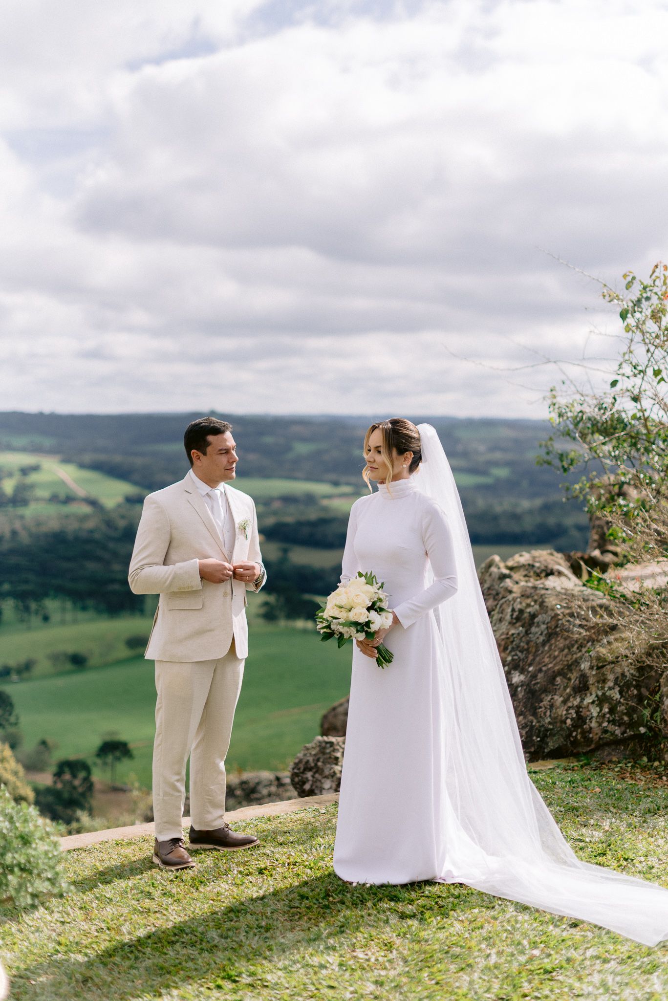 Romantic wedding photography session on a hilltop with dramatic landscape views.