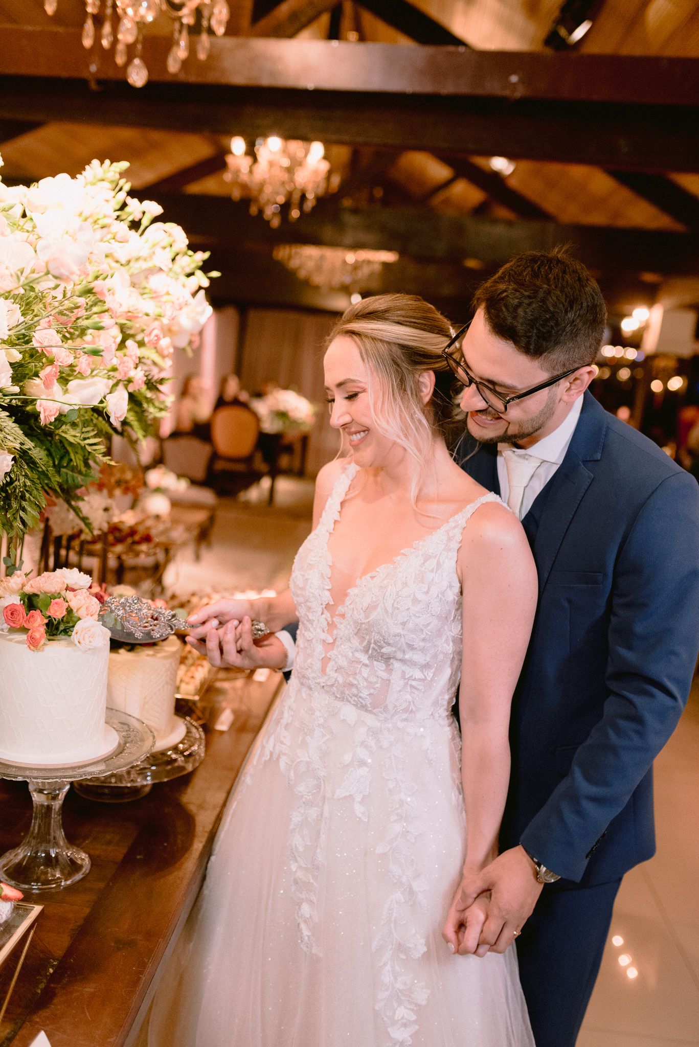 An intimate wedding reception moment captured with warm lighting and floral decorations.
