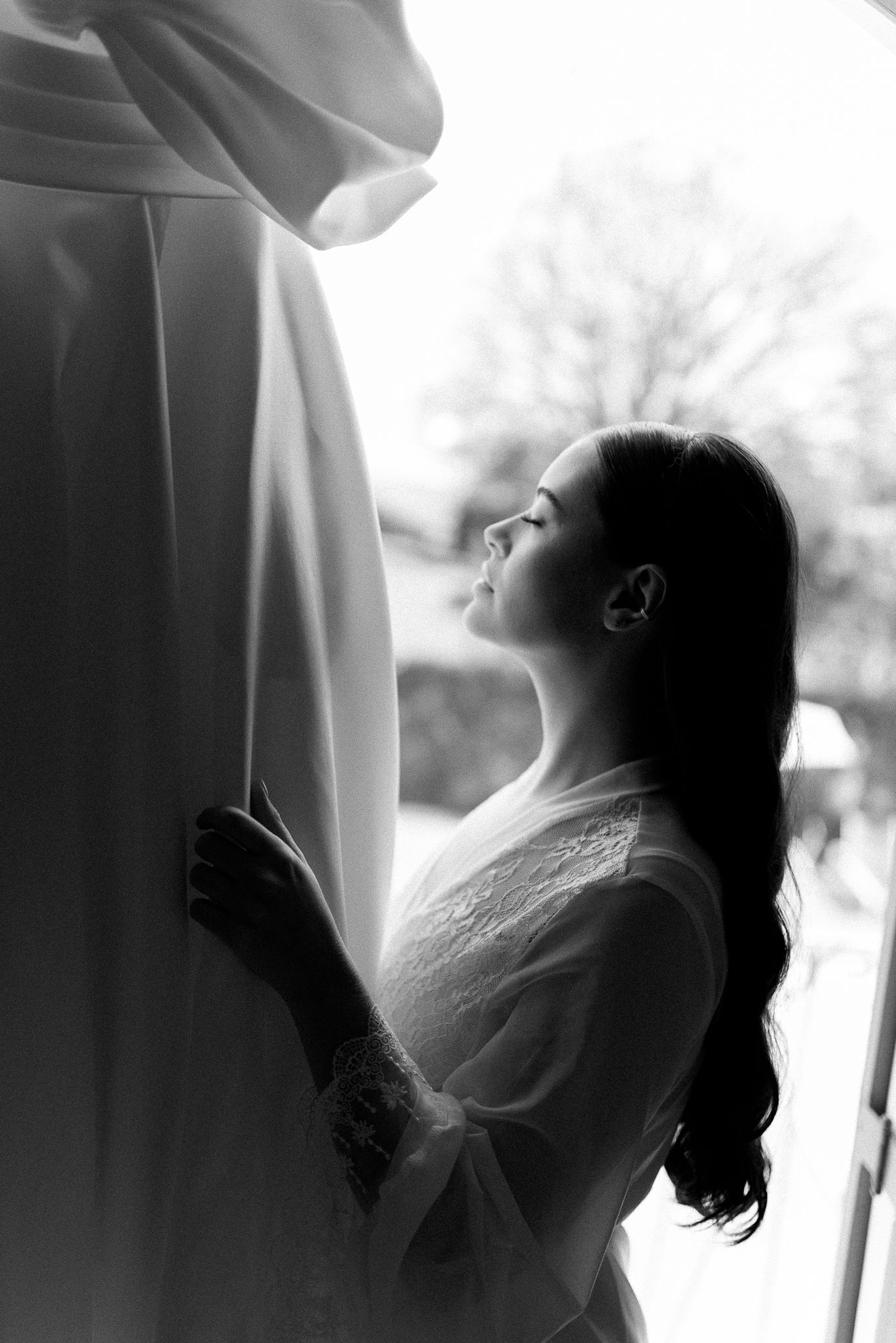 A black and white artistic photo sequence showing a person in profile looking upward with flowing fabric and hair.