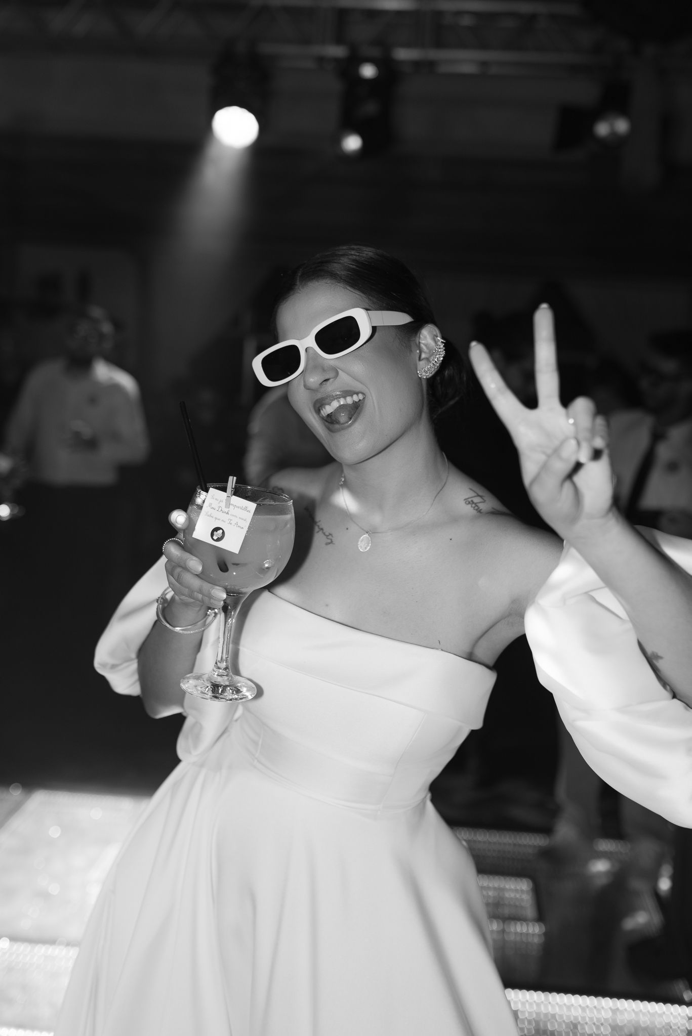 Wedding celebration on the dance floor with white sunglasses and joyful dancing.