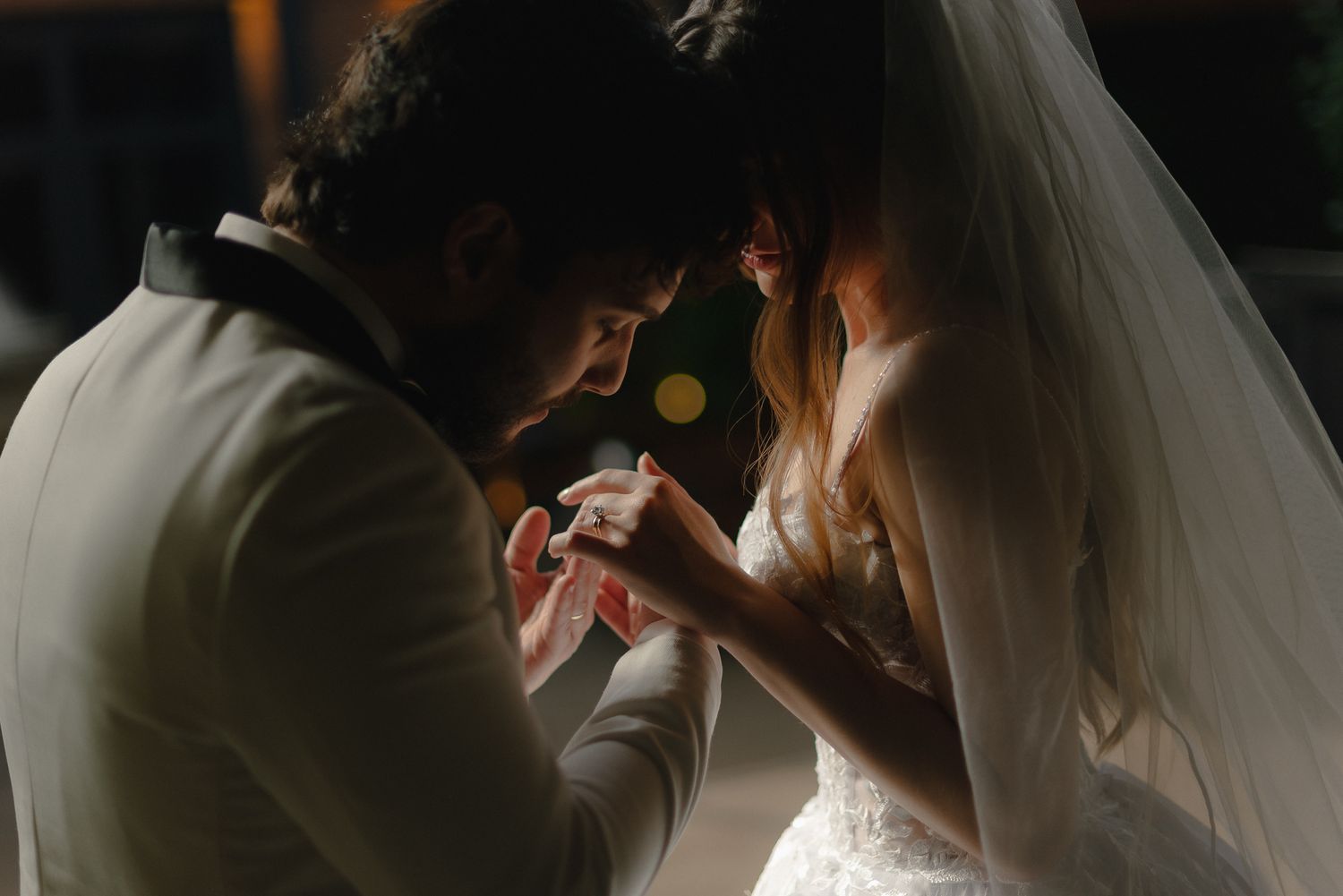 Intimate wedding couple photos captured in dramatic low-light conditions.
