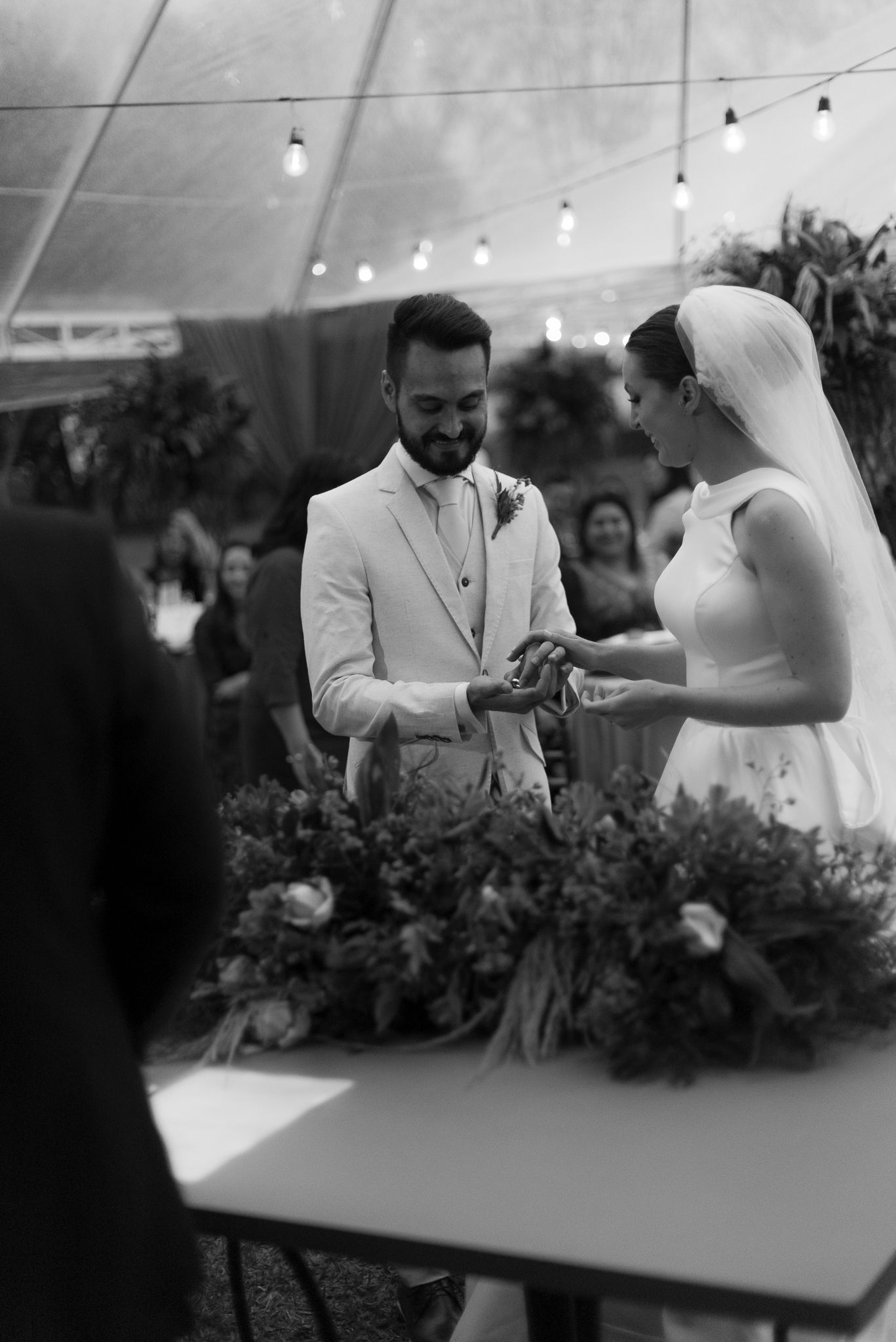 Wedding party enjoying a toast around an elegant dining table with floral decorations.