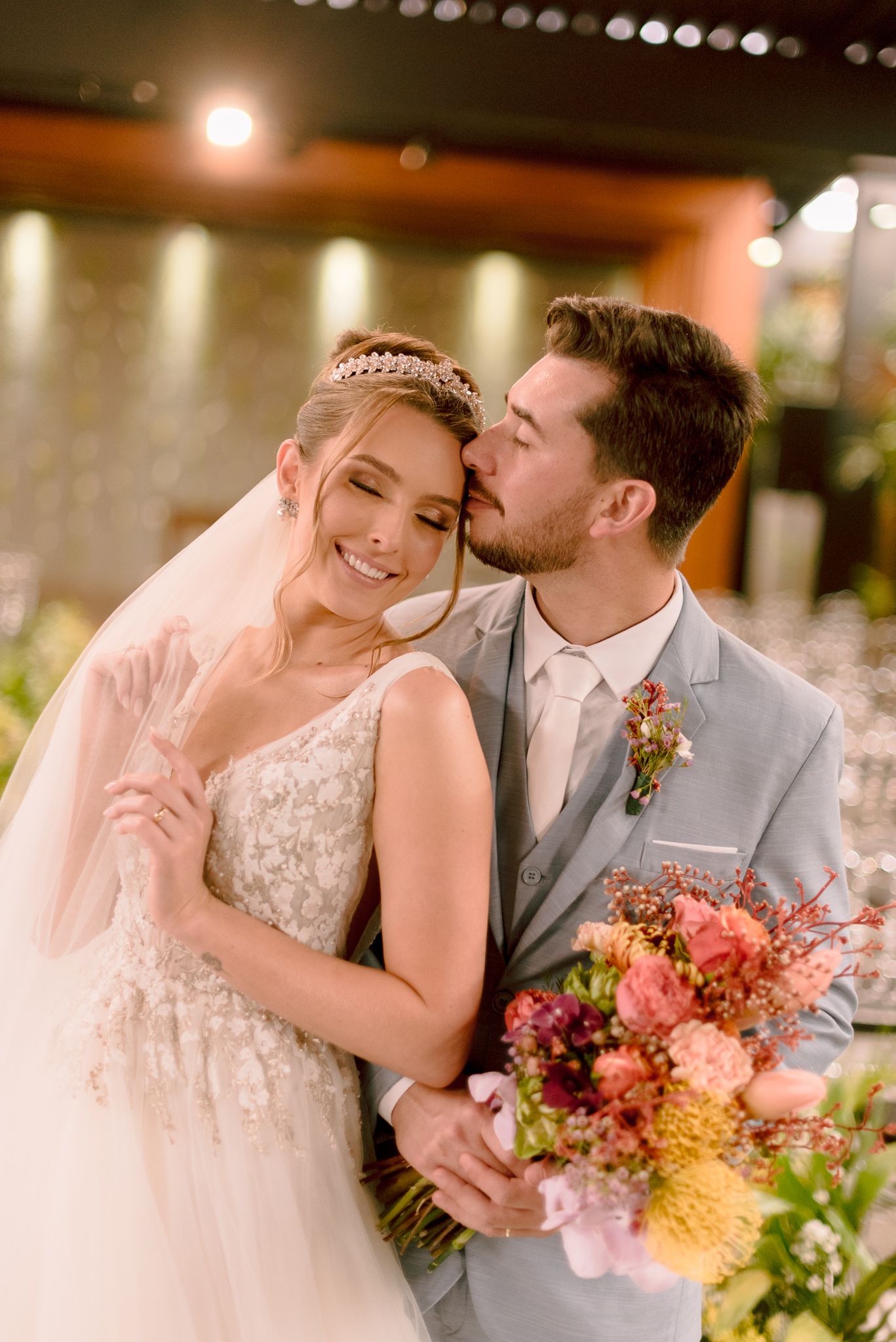 Romantic wedding portraits showing tender moments between newlyweds with string lights in background.
