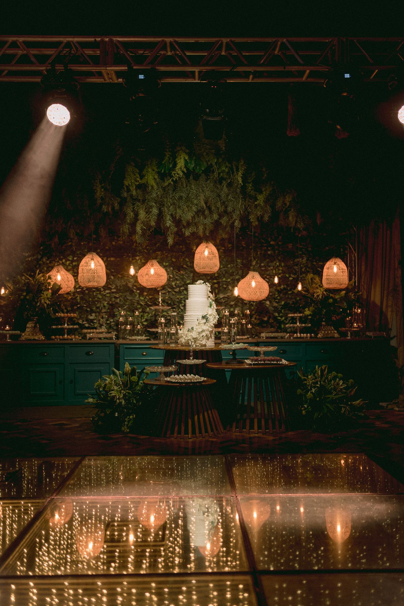 Wedding reception venue decorated with warm glowing lanterns and string lights creating romantic ambiance.