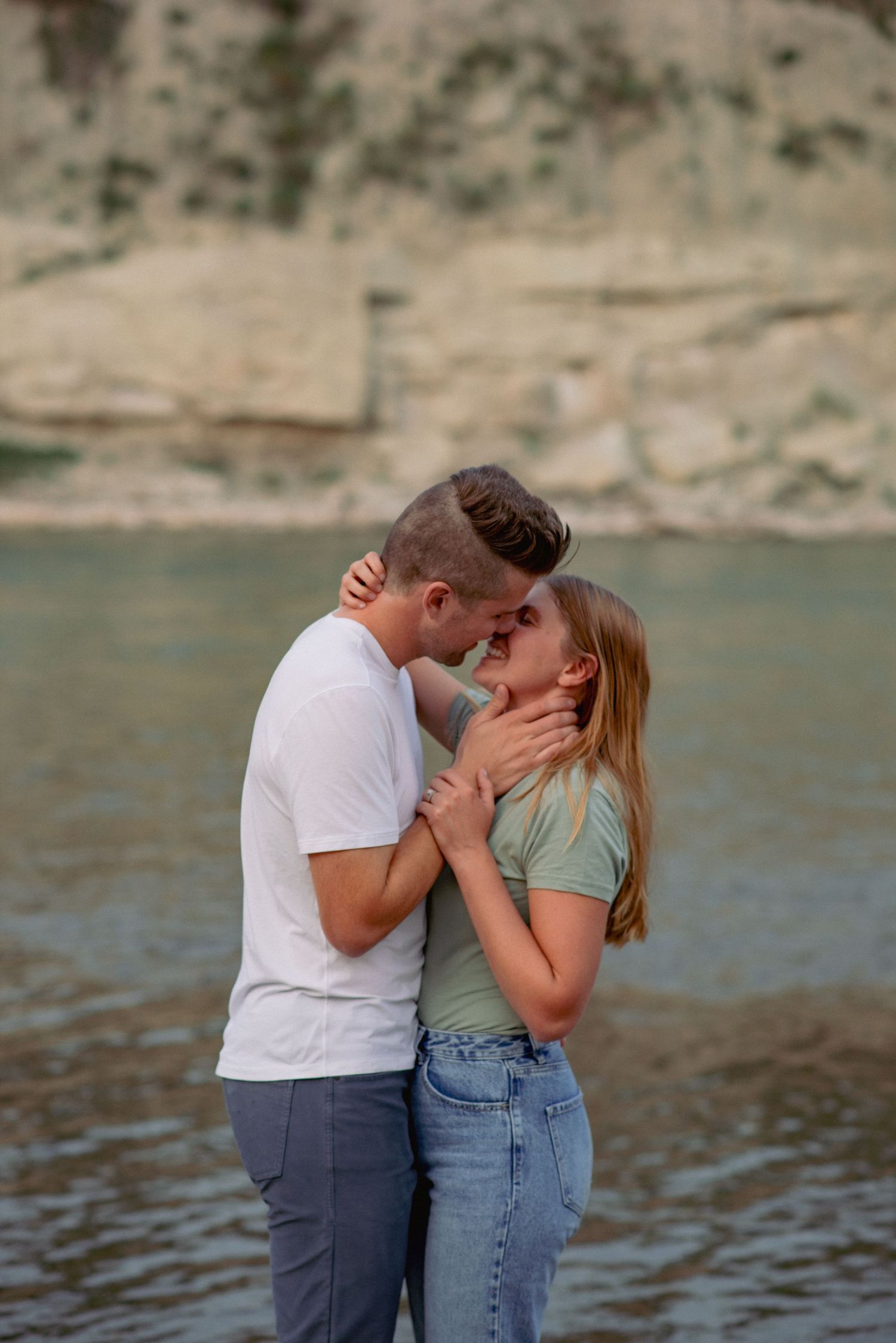 Outdoor couples photo session Rocky Mountains Alberta, romantic moment by river near Cochrane