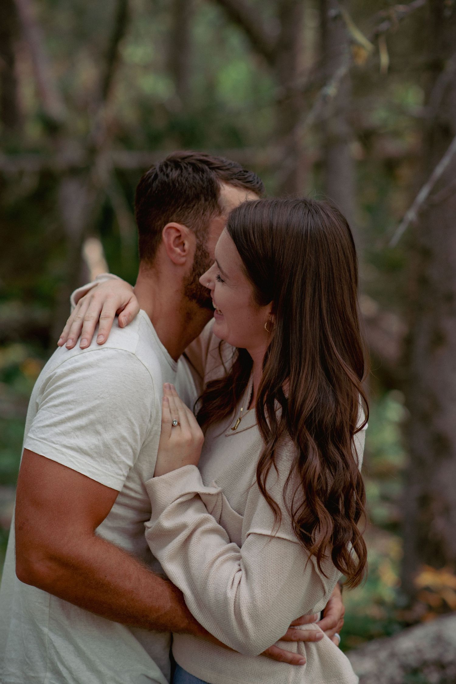 Professional couple photos Alberta, partners sharing close moment in scenic forest setting