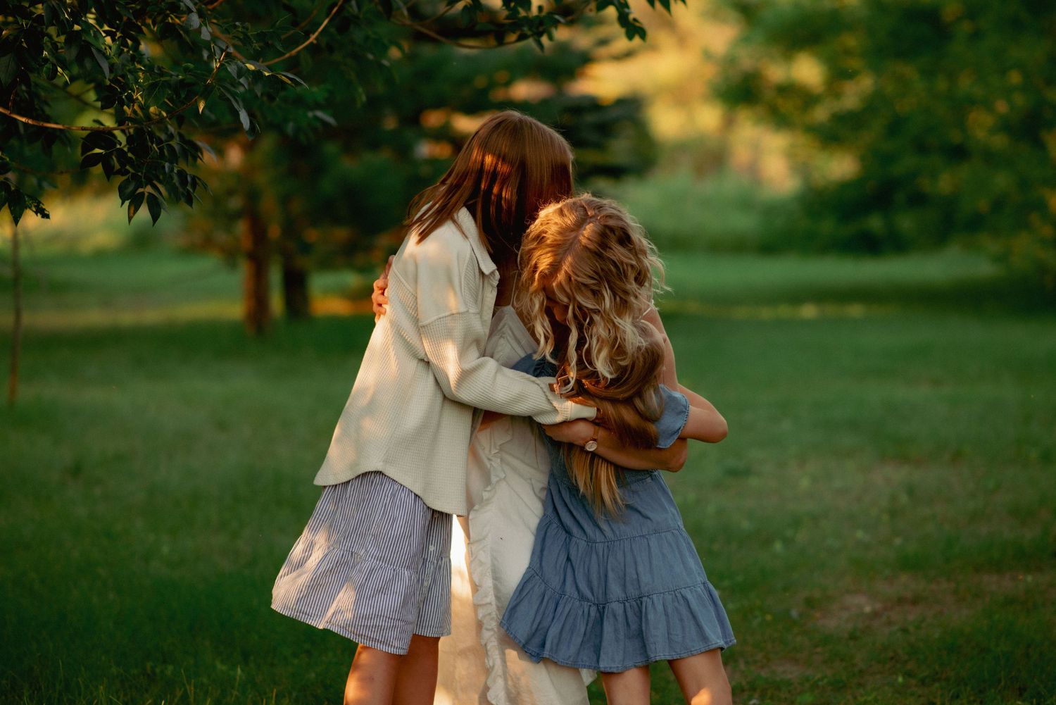 Cochrane family photographer capturing candid moments in the woods at sunset.