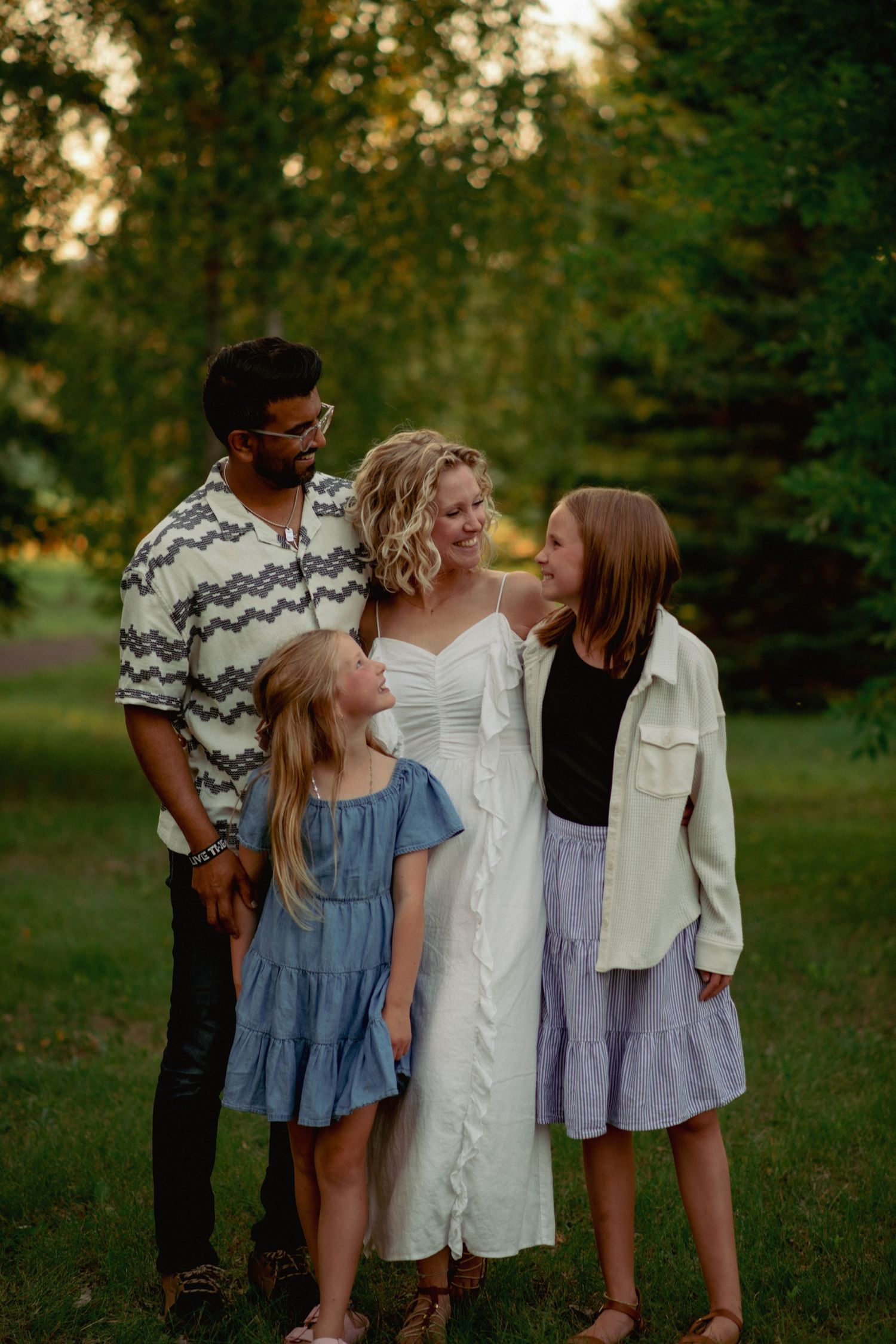 Natural light family portraits in Cochrane forest during golden hour