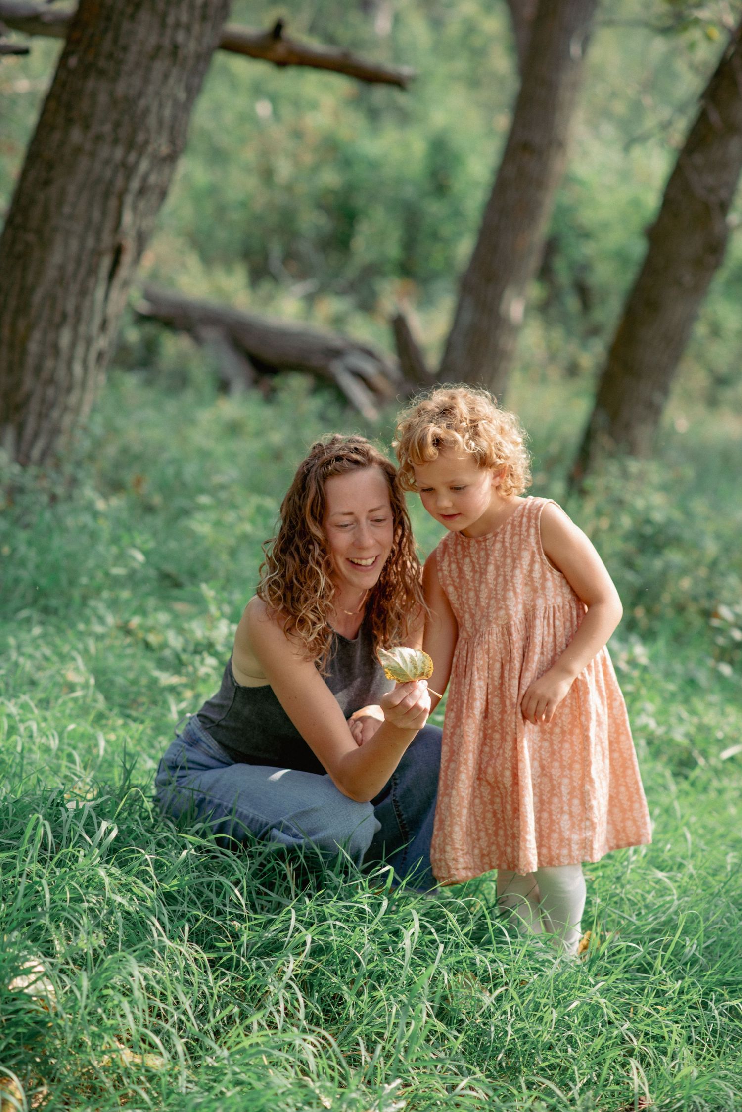 Candid family photography Rocky Mountains, mother and daughter exploring outdoors in scenic Cochrane park