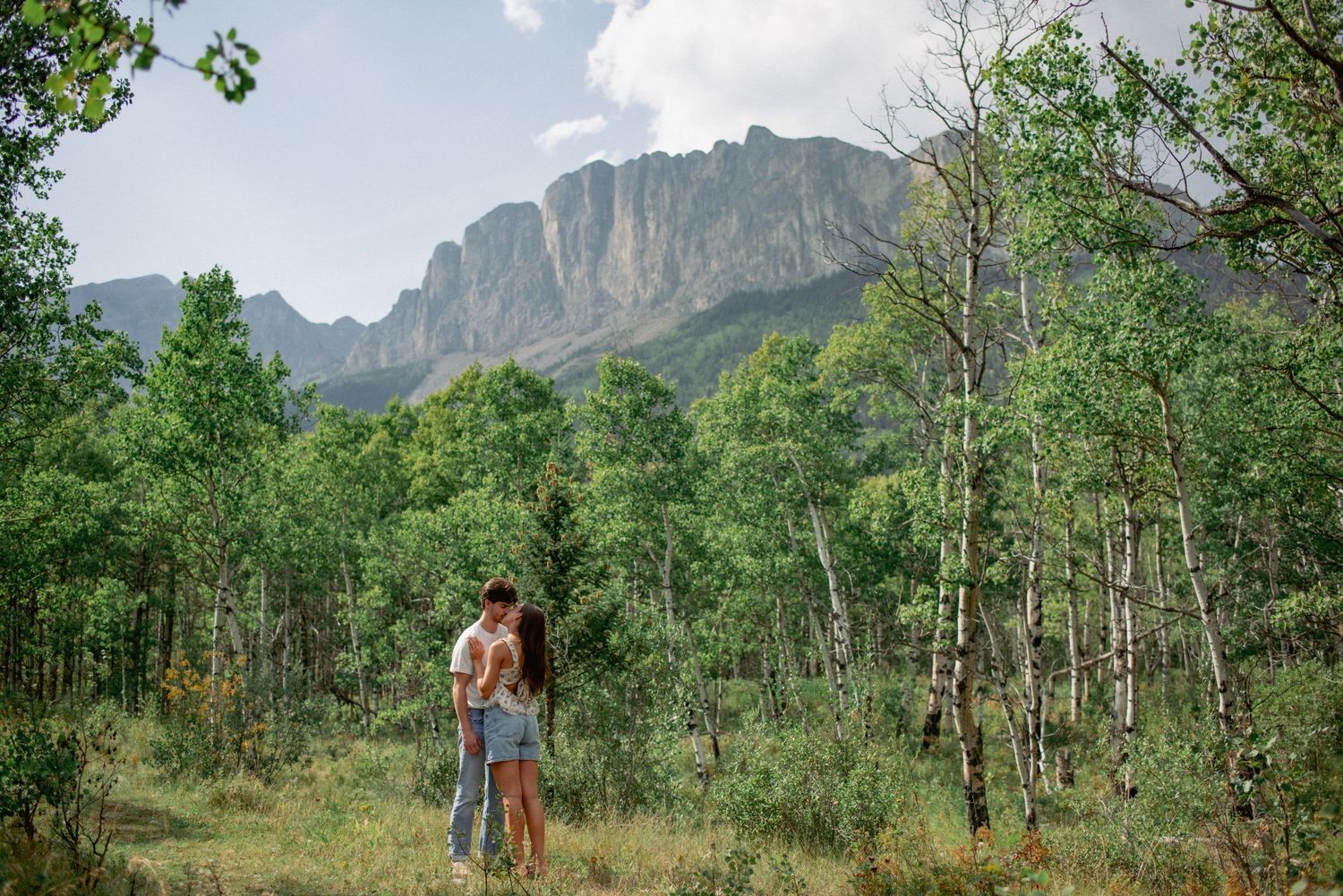 Candid couples photography Rocky Mountains, romantic laughter moment at Yamnuska