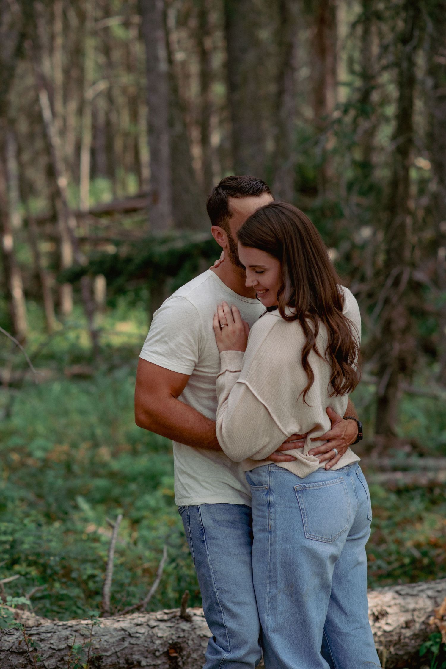 Professional couple photos Alberta, partners sharing close moment in scenic forest setting