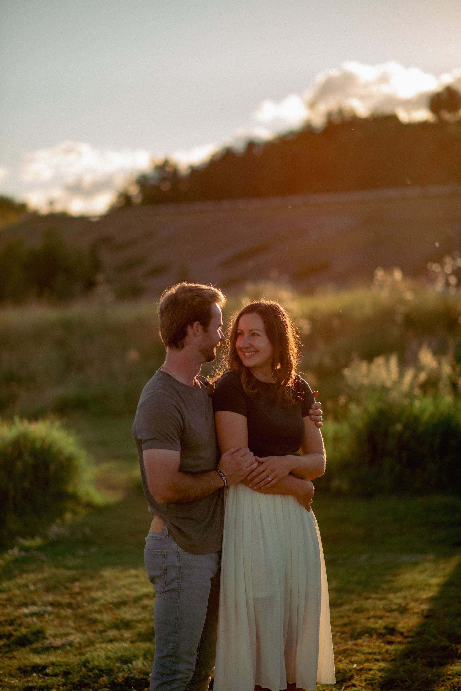 Alberta engagement photography, romantic couple intimately embracing during golden hour at Ghost Lake