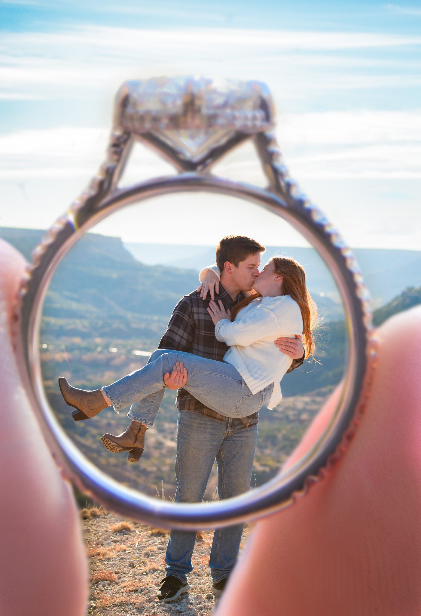 Creative engagement photo captured through sunglasses reflection on mountain overlook.