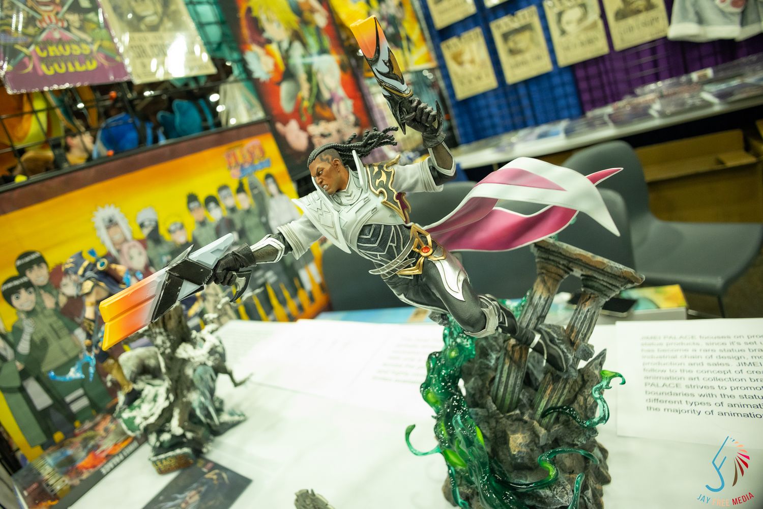 Detailed fantasy warrior action figure with sword displayed at comic convention merchandise table.