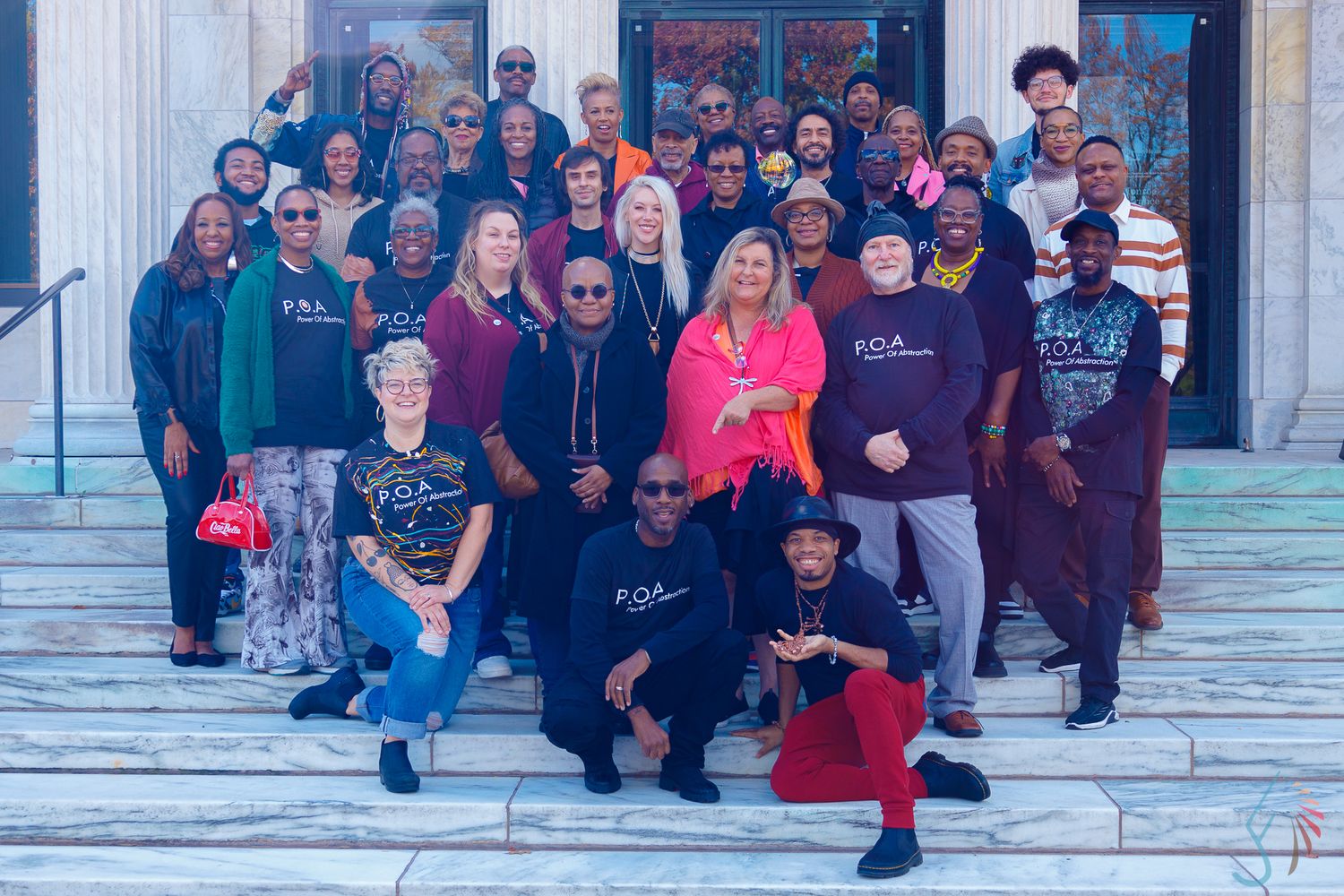 Members of the Power of Abstraction group posing together on steps of Toledo Museum of Art for a memorable group photo.