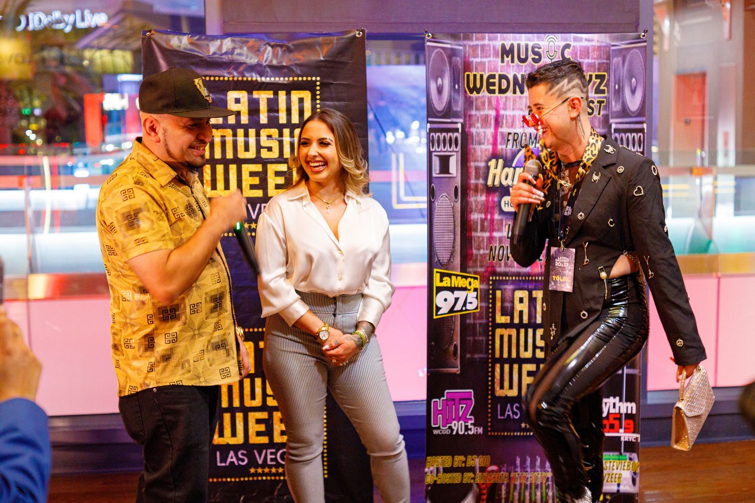 Three people laughing at Latin Music Week Las Vegas event.
