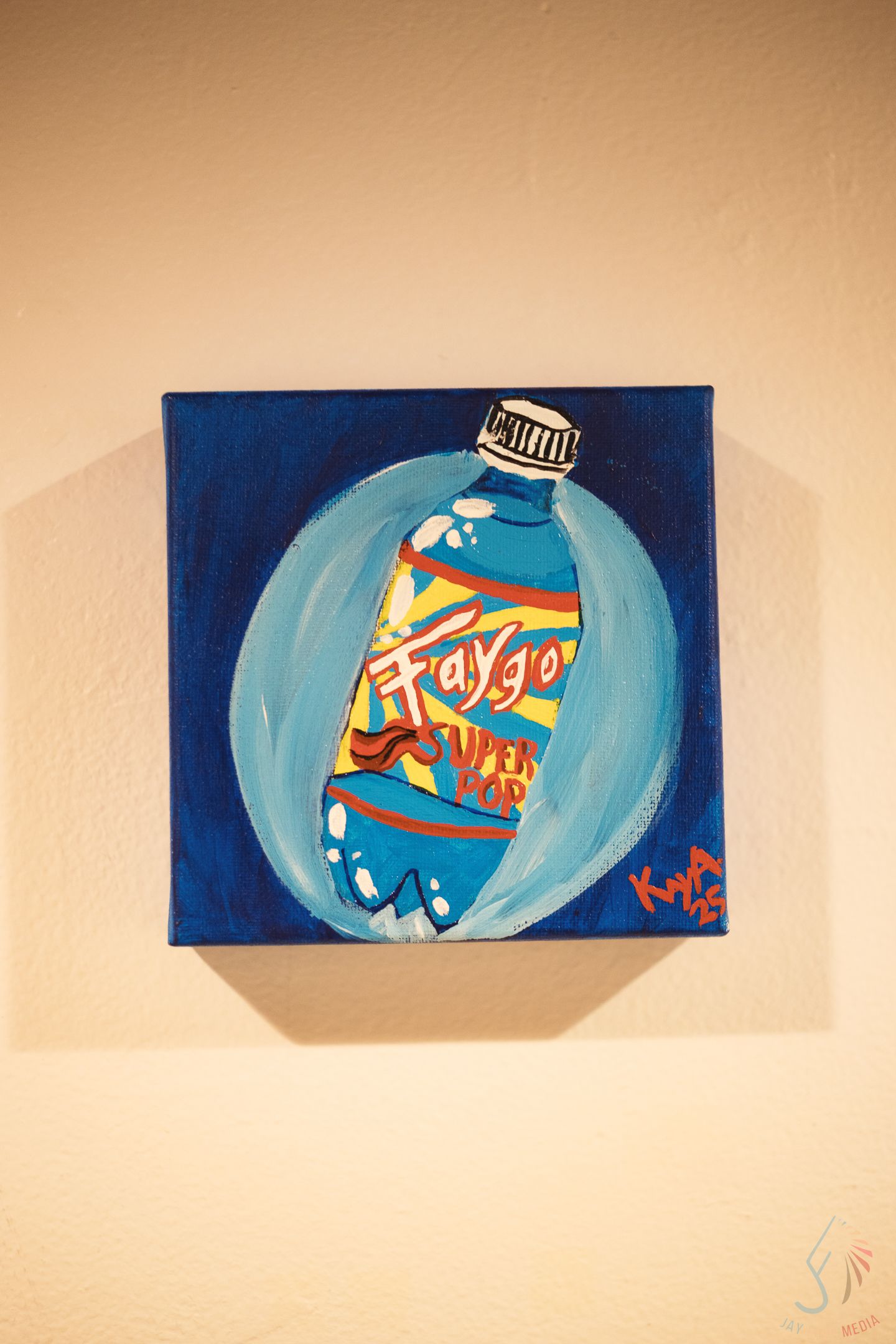 Colorful pop art painting of Faygo soda bottle on blue canvas displayed on wall.