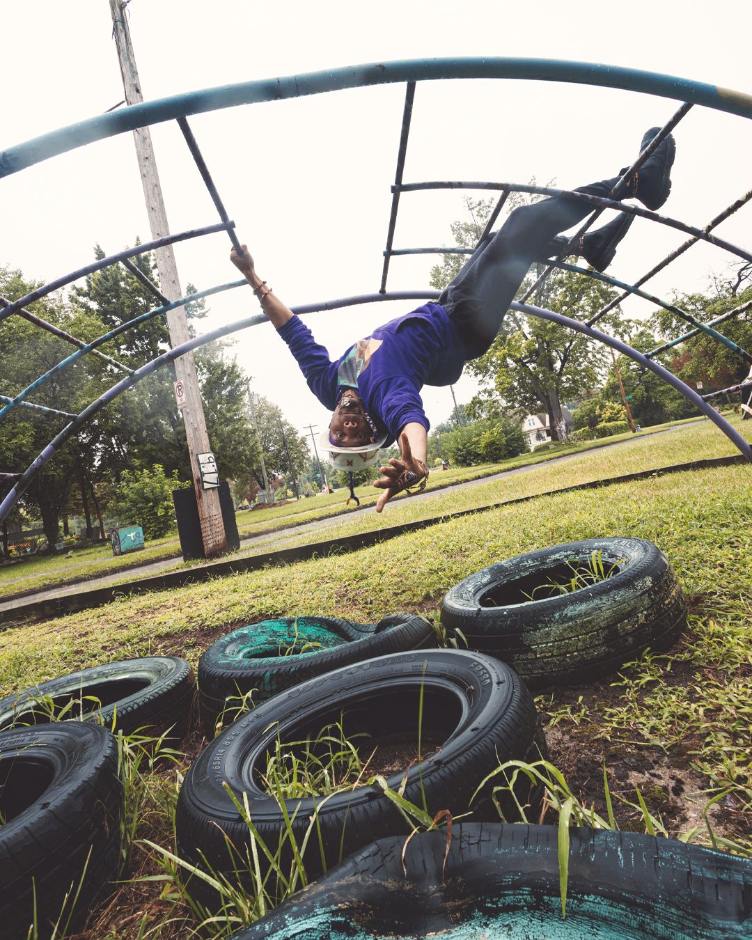 Dynamic shots of someone performing acrobatic moves on exercise equipment over tires.
