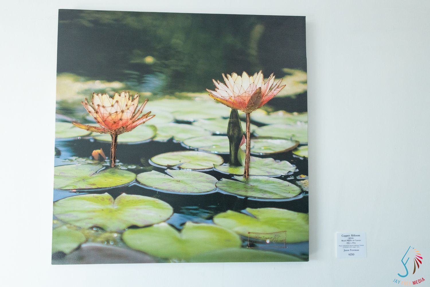 Canvas print of vibrant pink water lilies blooming among green lily pads on a tranquil pond.