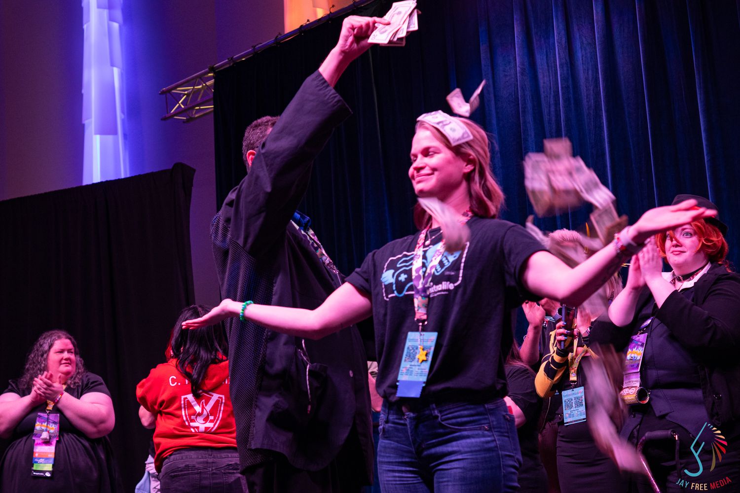 Woman raising award on stage at a cosplay competition at a convention event.