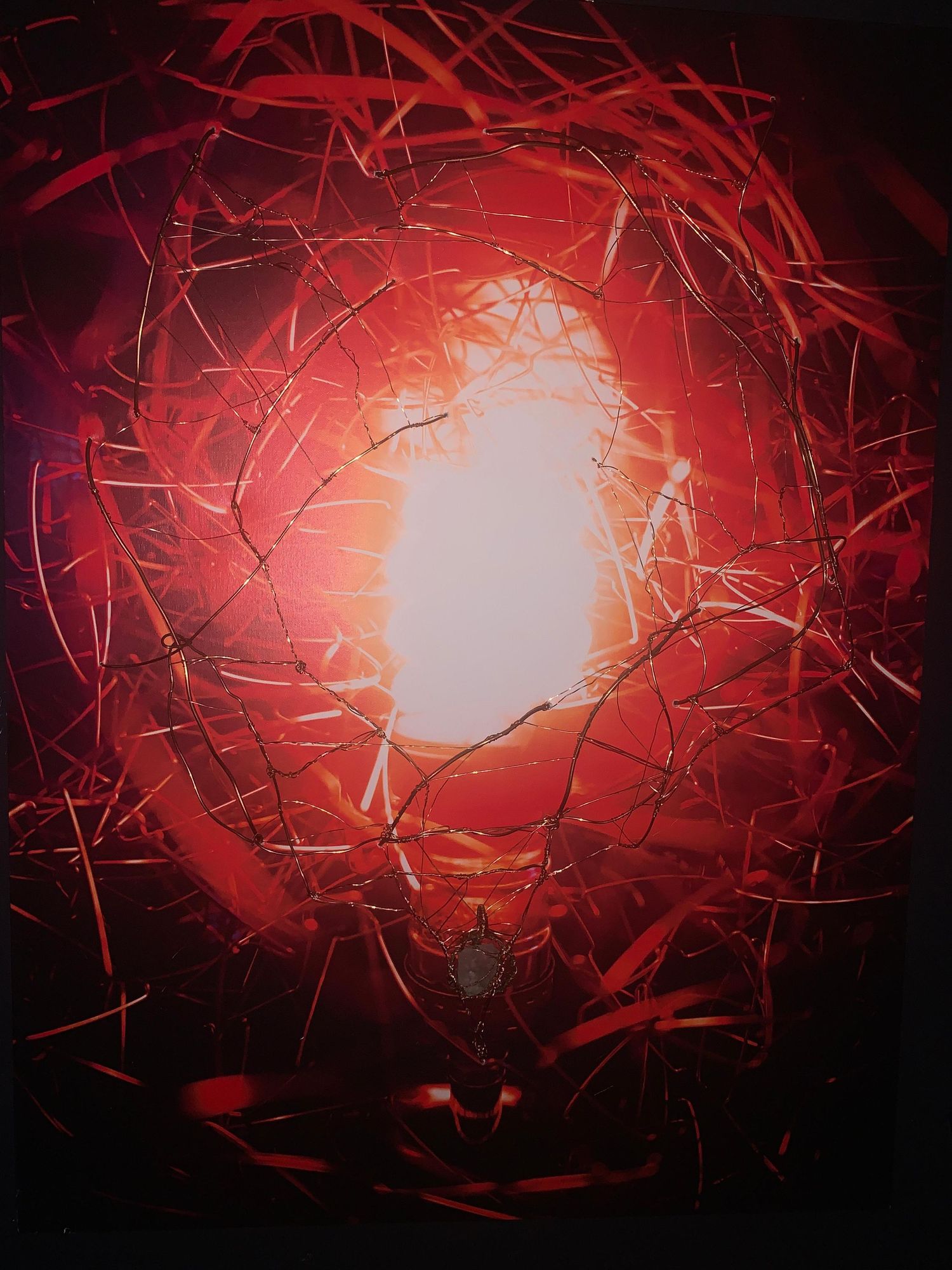 Abstract red glowing light burst through tangled branches creating an intense fiery vortex effect in dark surreal art.