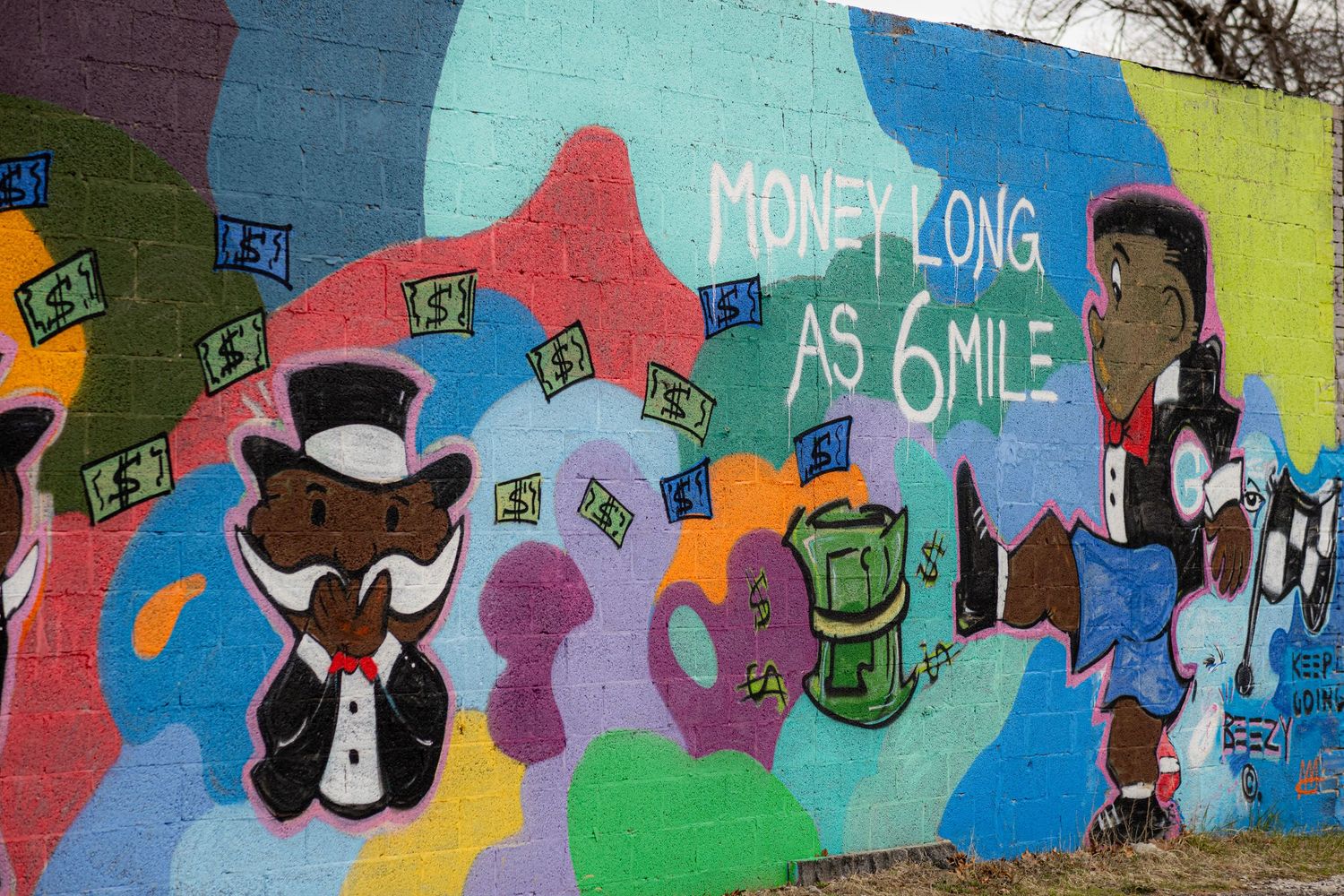 Colorful street mural with cartoon characters and text reading Money Long As 6Mile on a brick wall.