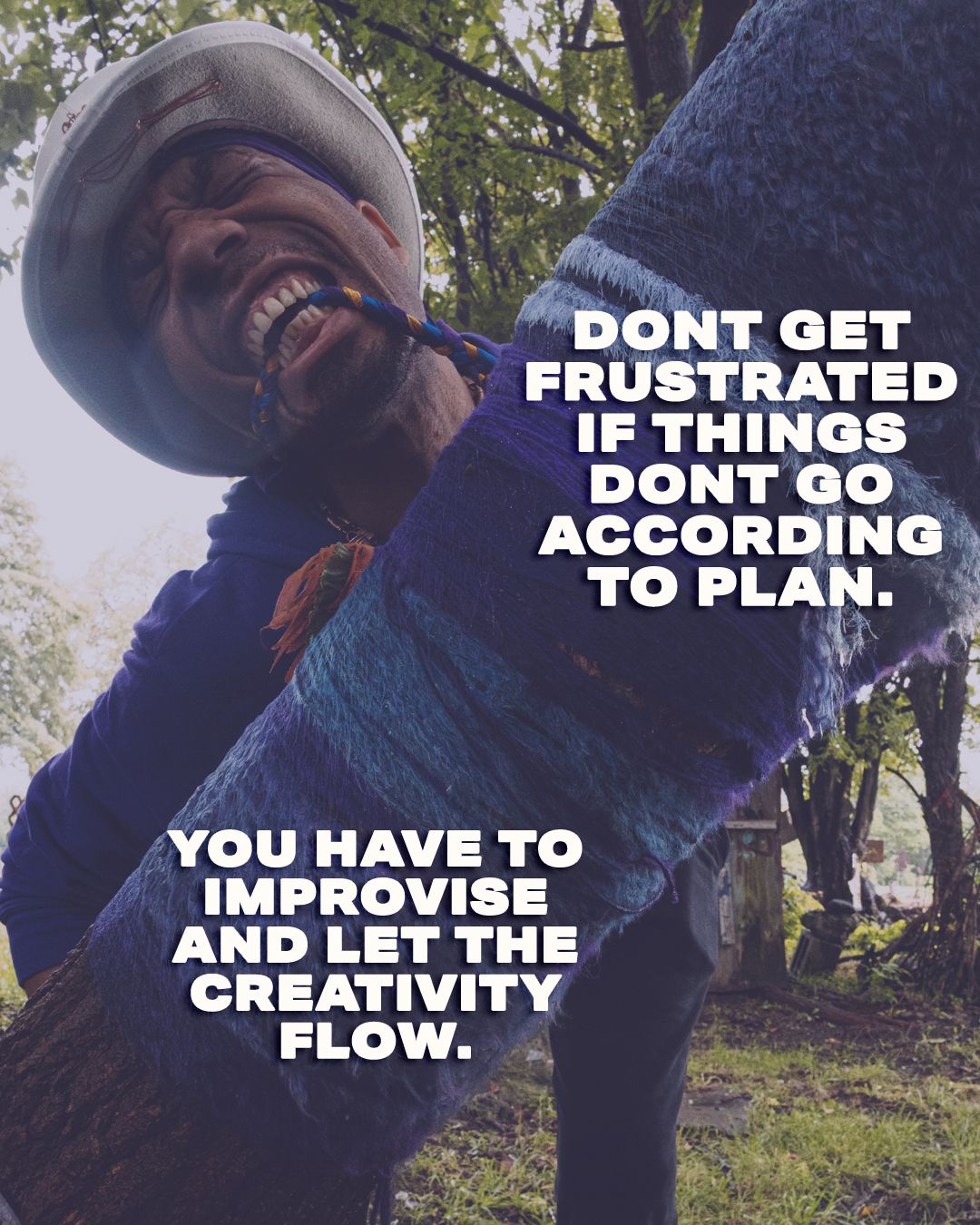 Motivational quote about improvising and letting creativity flow overlaid on a smiling person leaning against a tree.