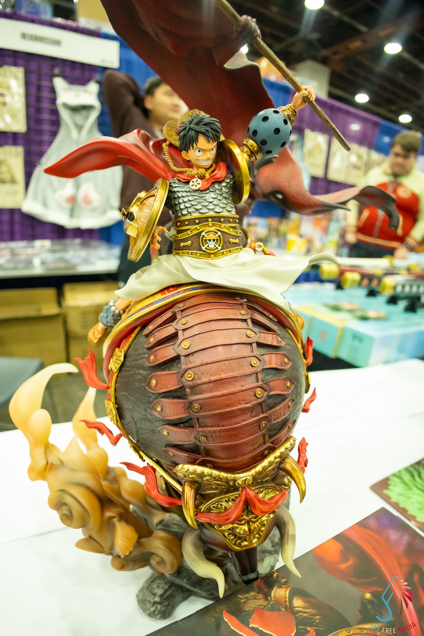 Intricate Monkey D. Luffy samurai collectible statue with red armor displayed at anime convention.