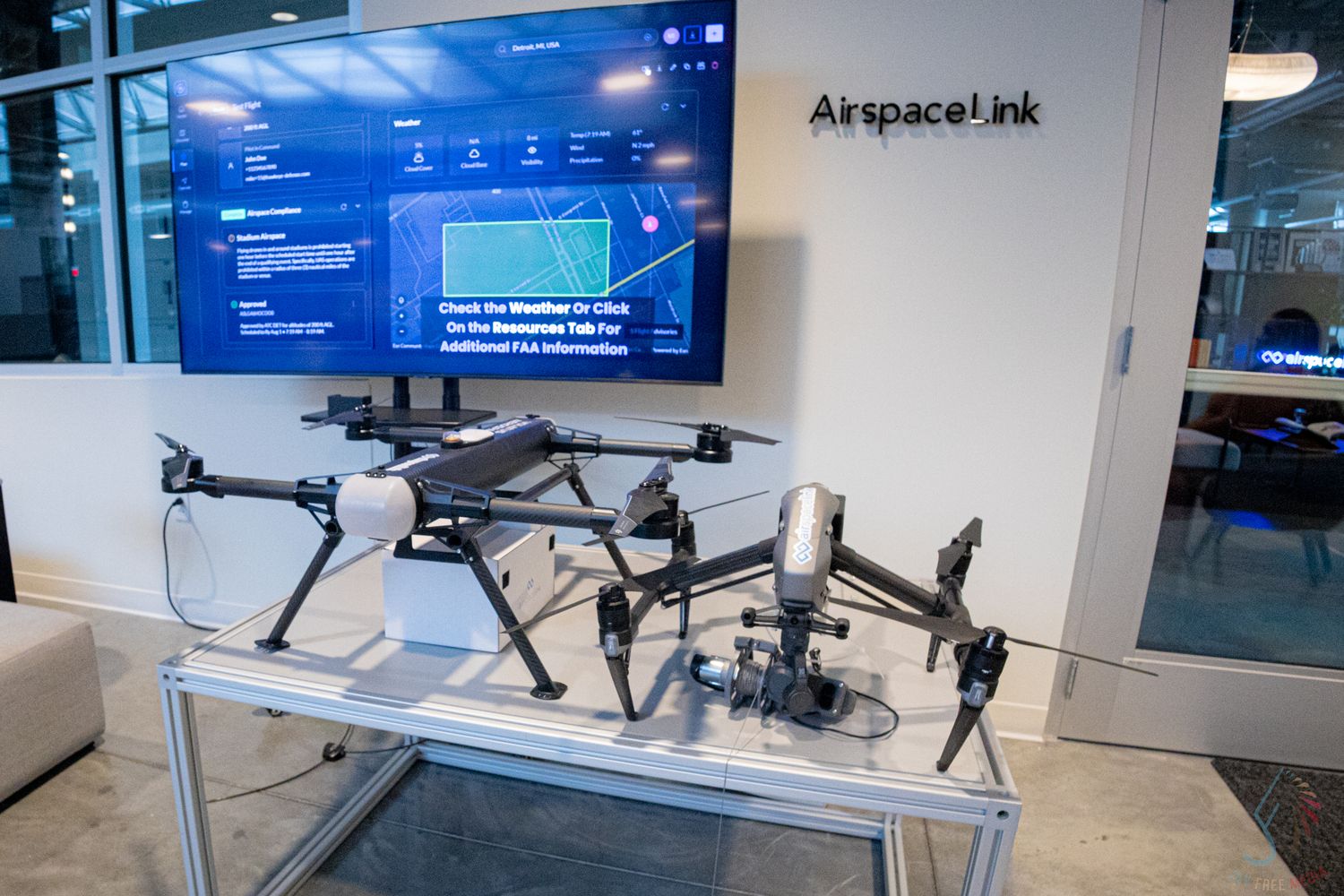 DJI drones on display at AirspaceLink technology showcase in modern office space.