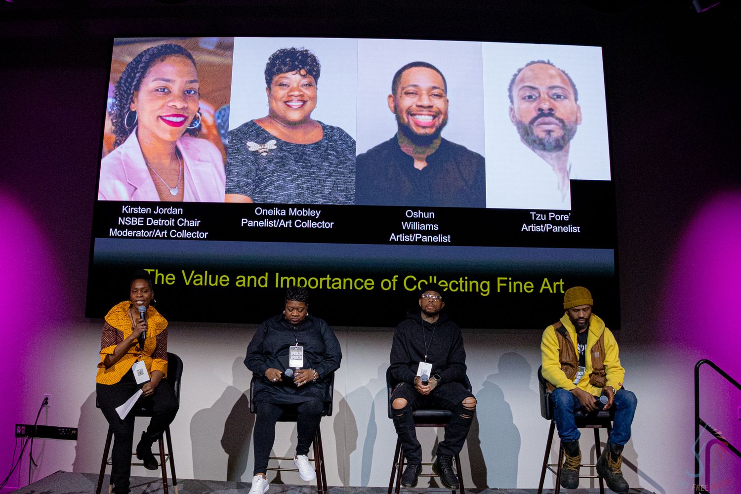Panel discussion on collecting fine art with four speakers seated on stage beneath a projected slide at an indoor event.