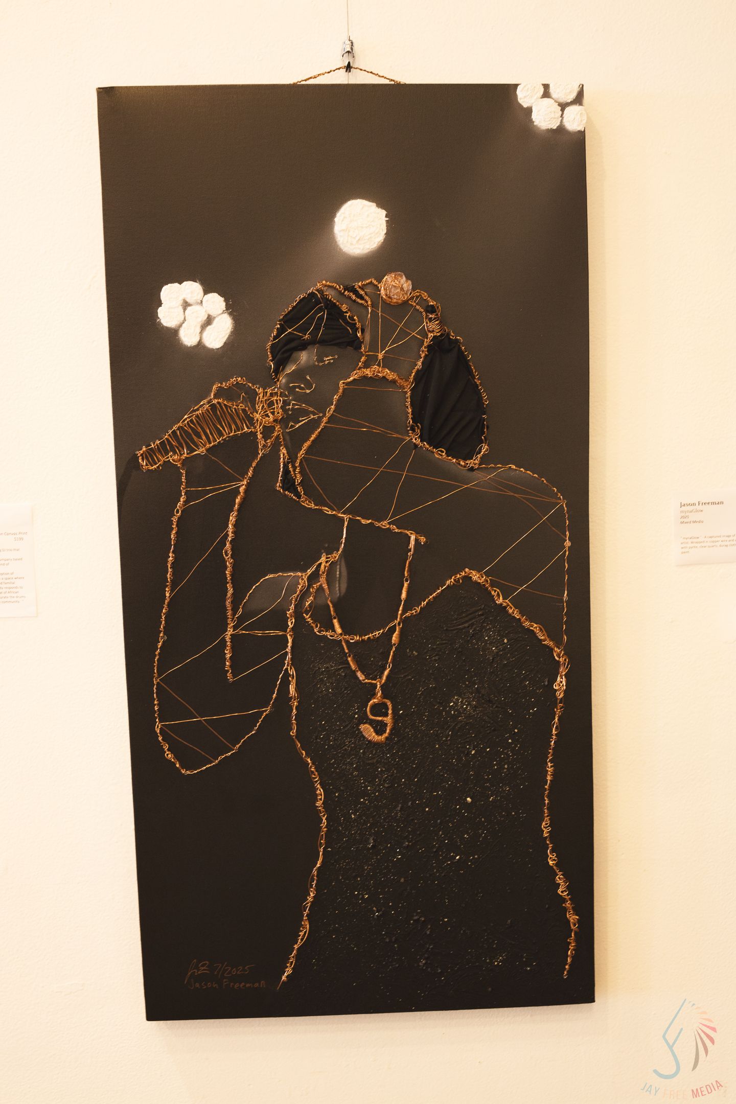 Black canvas artwork depicting a singer holding a microphone, outlined in copper wire with geometric patterns on dark background.