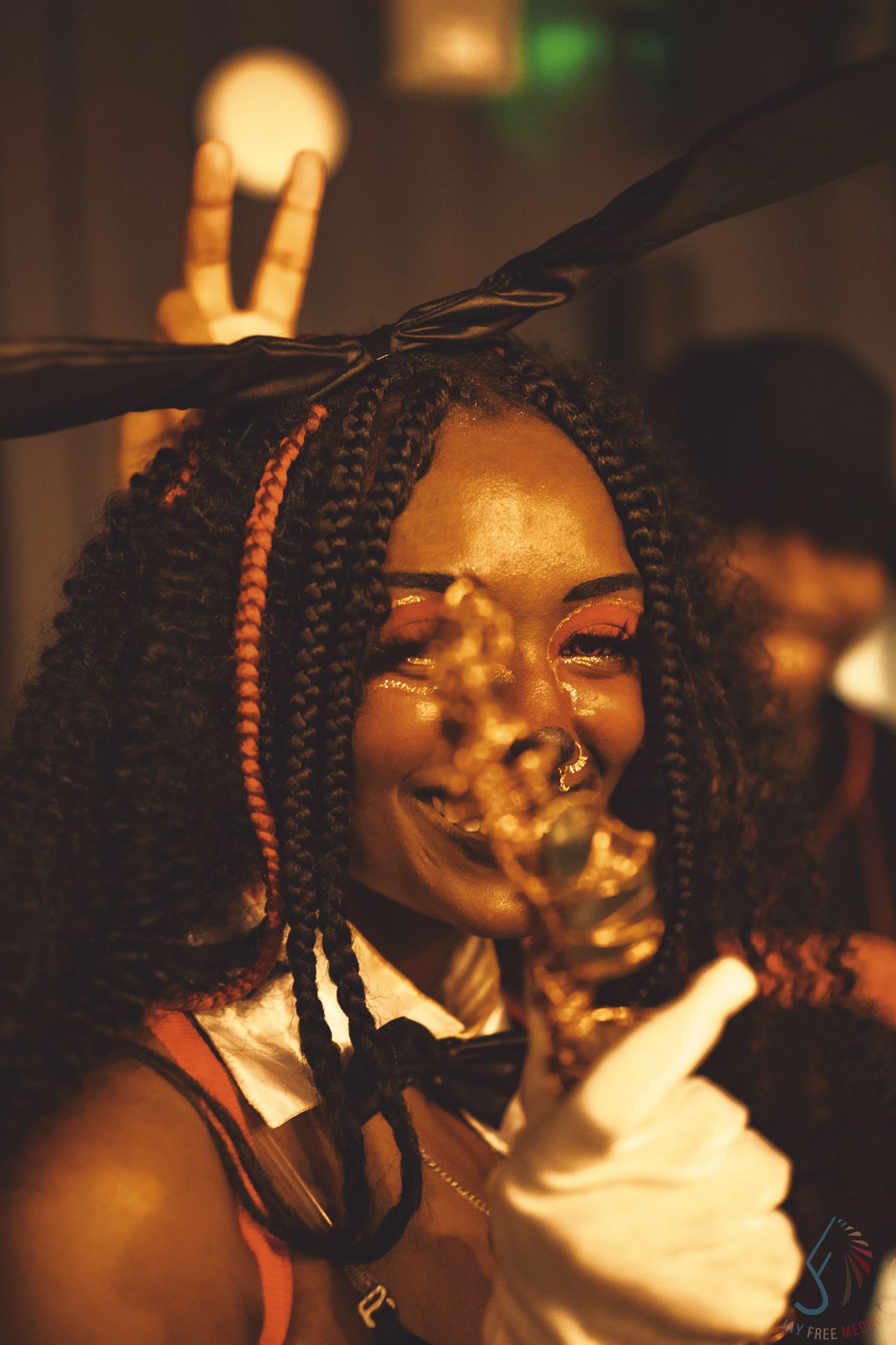 Artistic low-light portrait with soft golden lighting and sparkle effects.