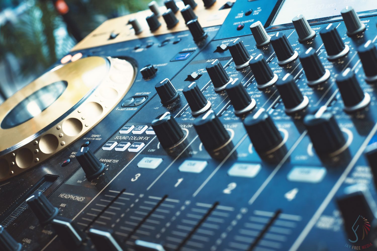 Close-up of a professional DJ mixer console with knobs, faders, and turntable platters in blue lighting.
