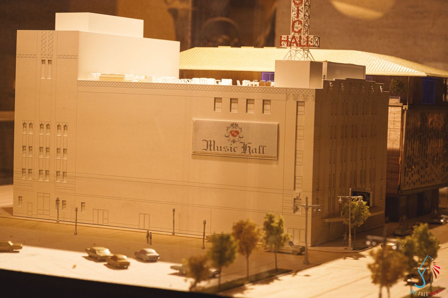 Architectural scale model of a Music Hall building displayed under warm lighting.