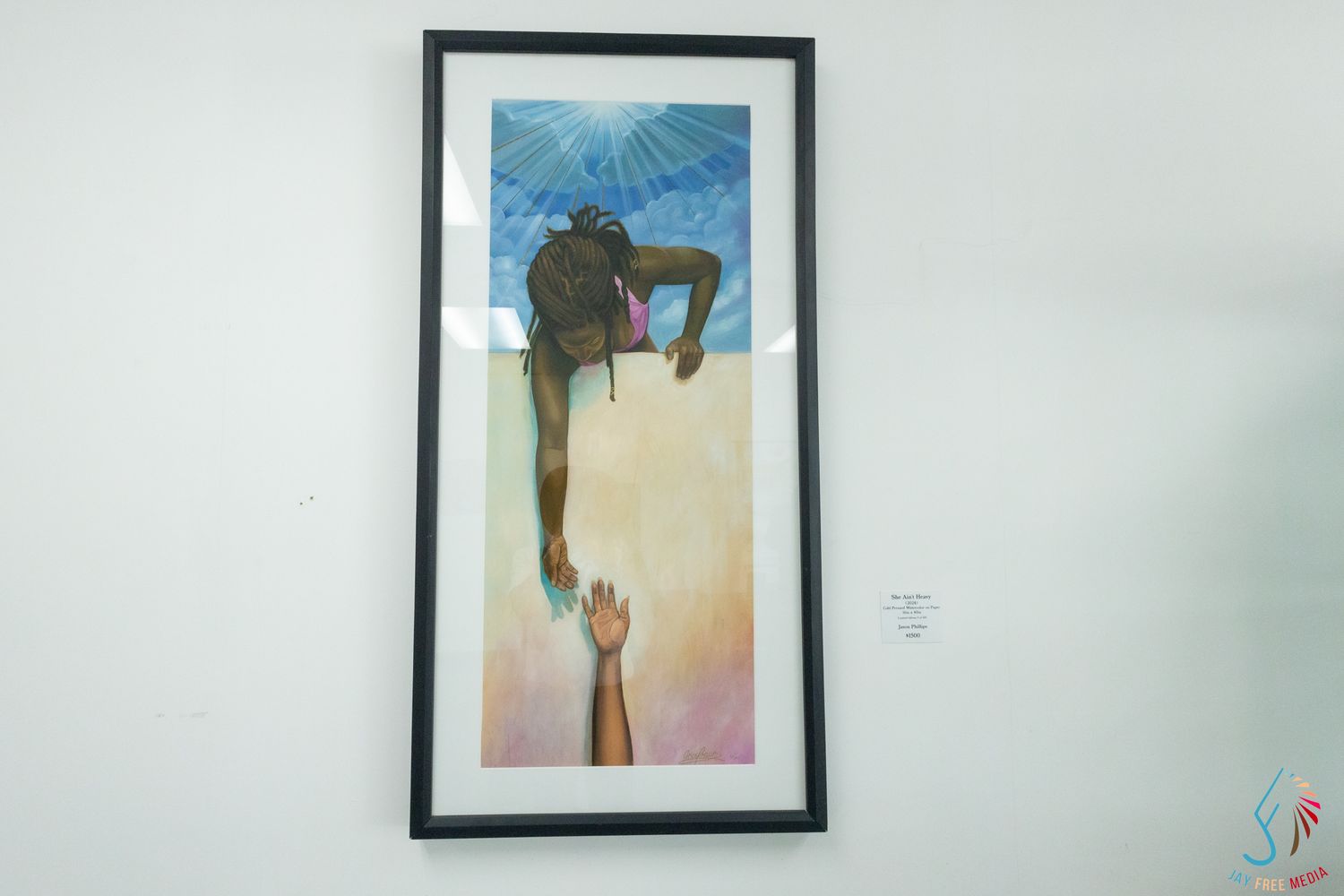 Framed artwork depicting a figure reaching down toward an outstretched hand against a colorful background.