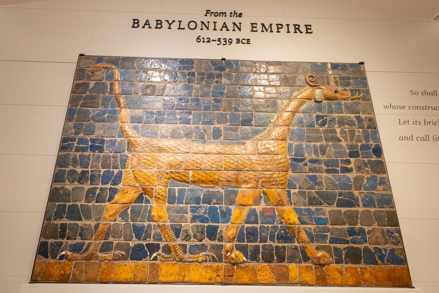 Ancient Babylonian Empire mosaic tile artwork depicting a golden animal figure on blue tiles, 612-539 BCE.