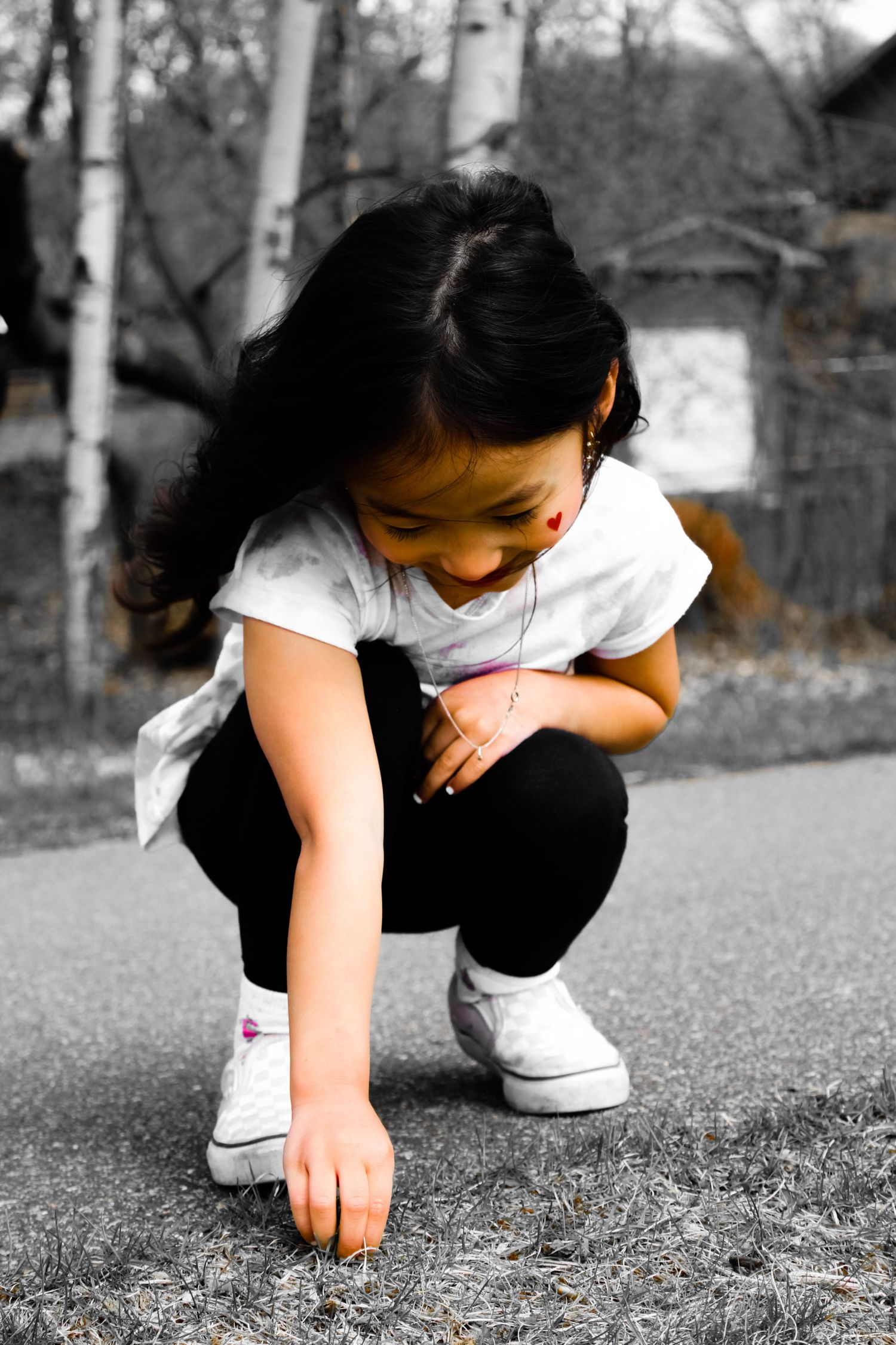 Black and white artistic sequence showing someone crouching down to touch the ground.