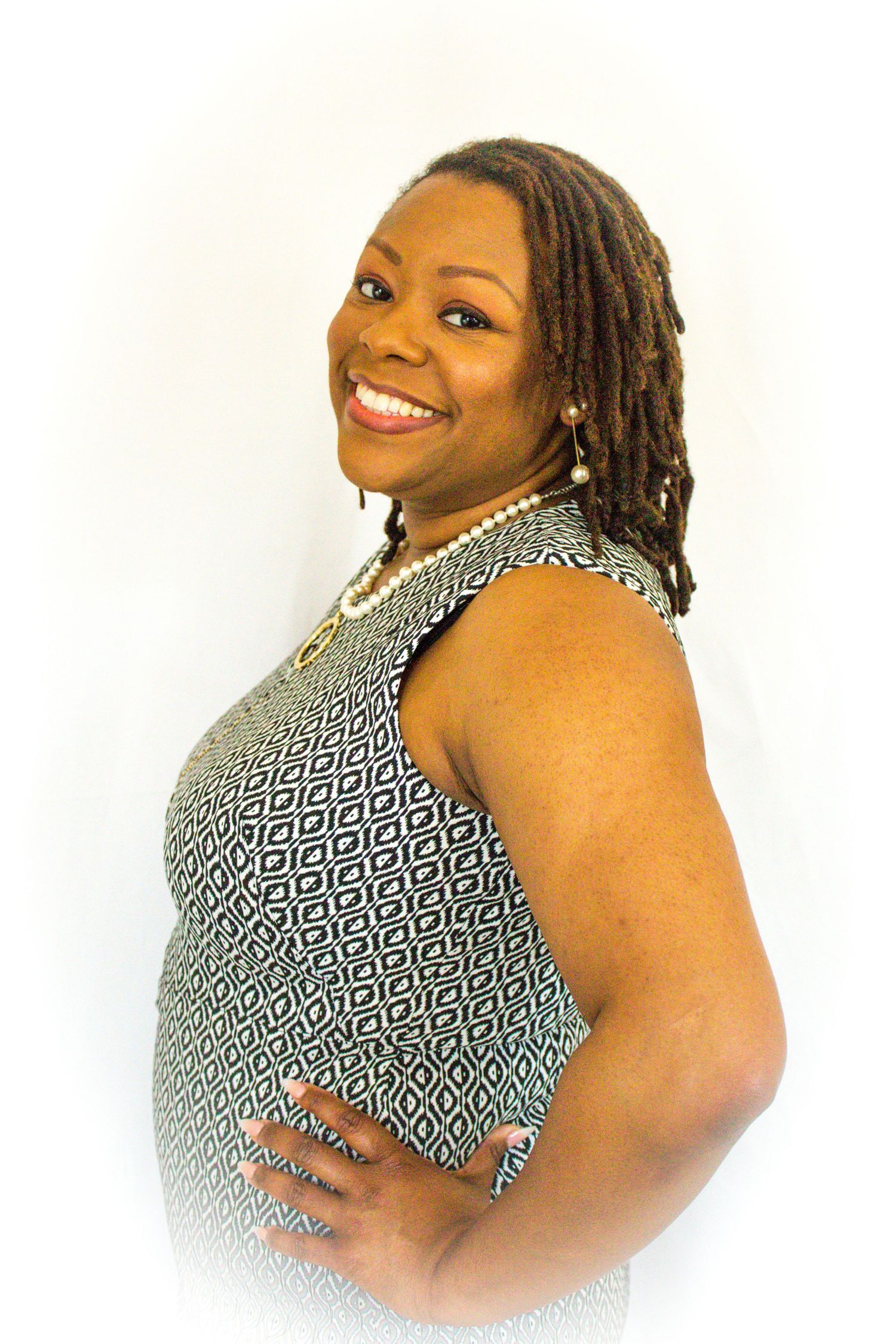Studio portrait series in black and white geometric print top against white background.