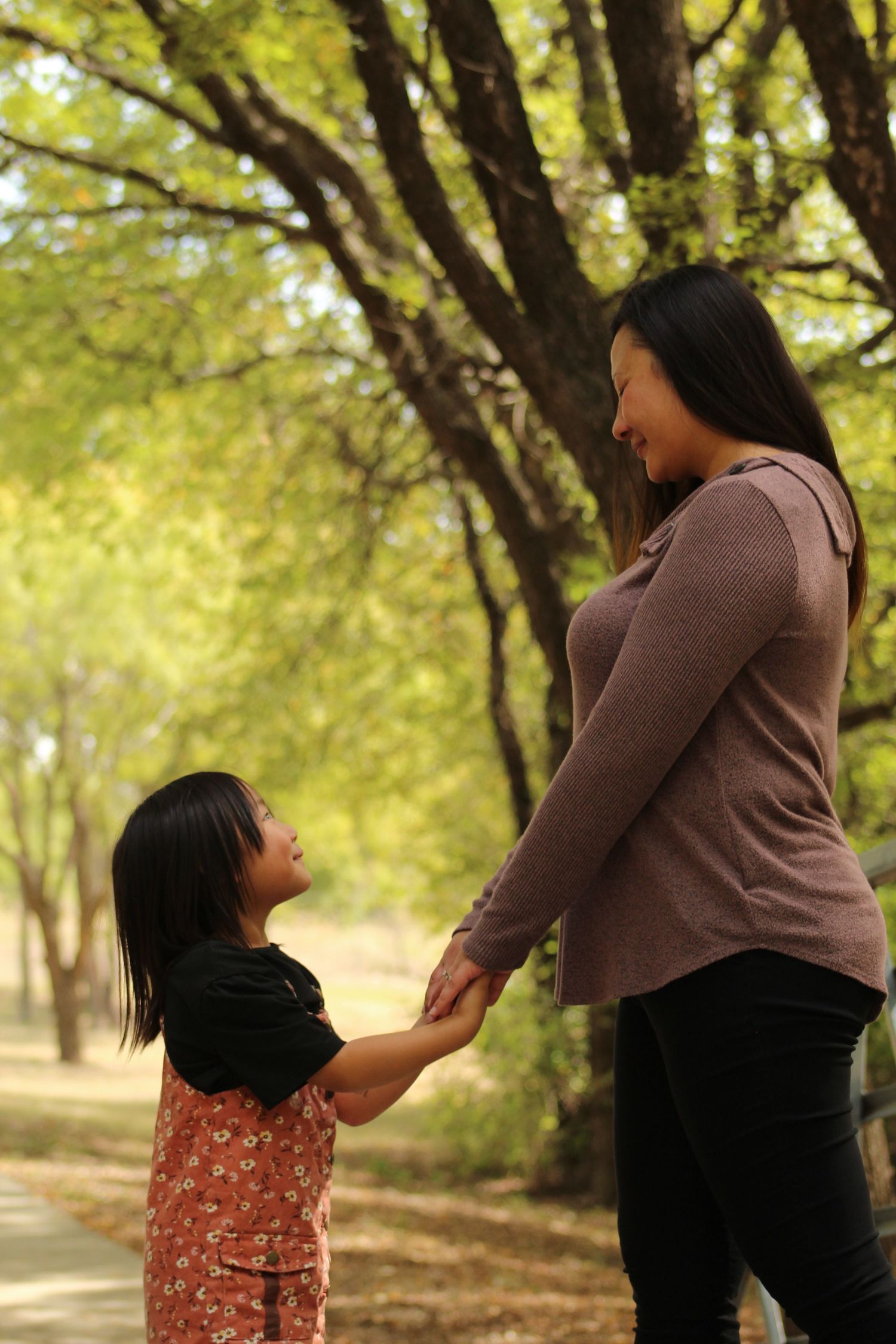 Sequence of candid interaction shots between two people in a wooded setting.
