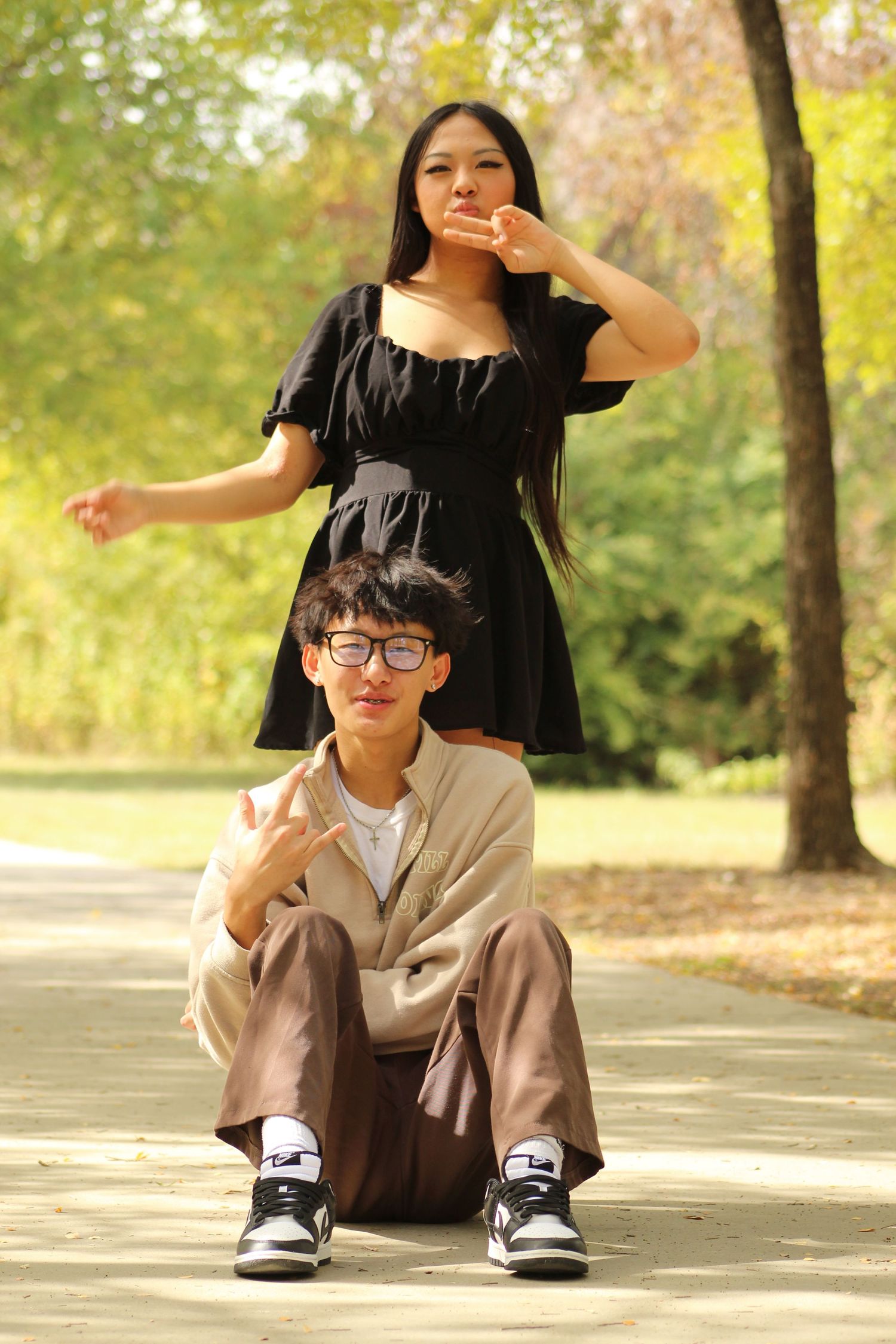 Casual photo sequence in a park with someone in beige and black clothing making playful poses.