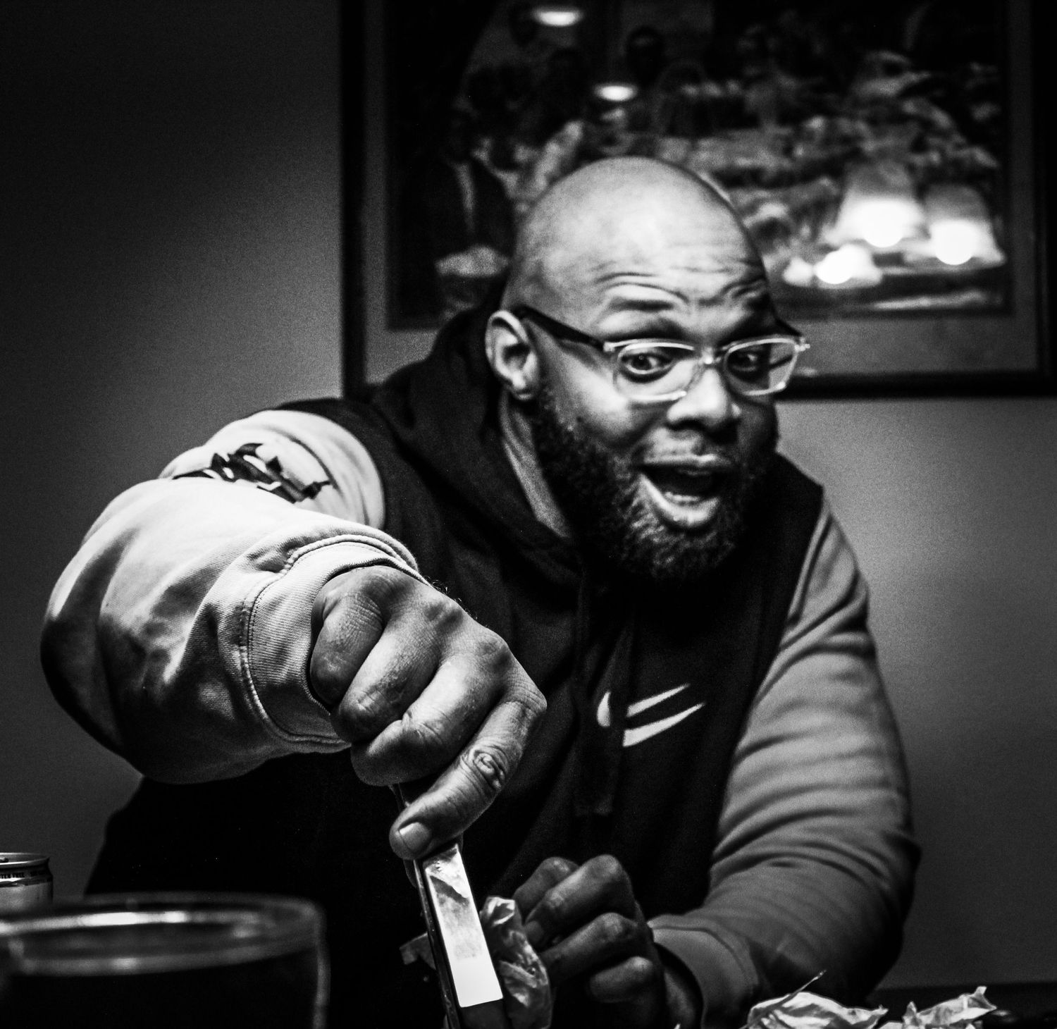 Dramatic black and white portrait series with low-key lighting in an indoor setting.