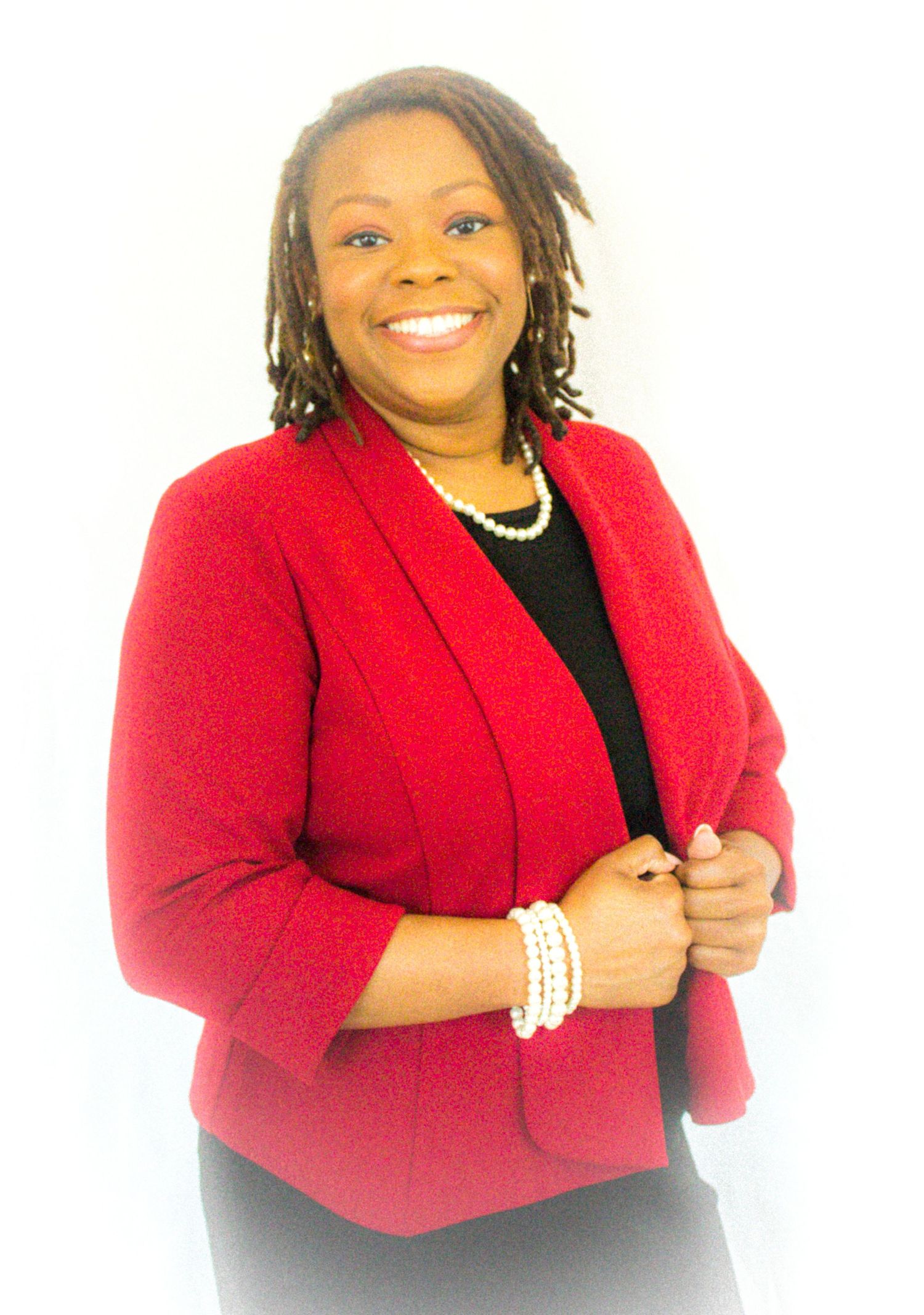 Portrait series in bright red blazer and black top with pearl accessories.
