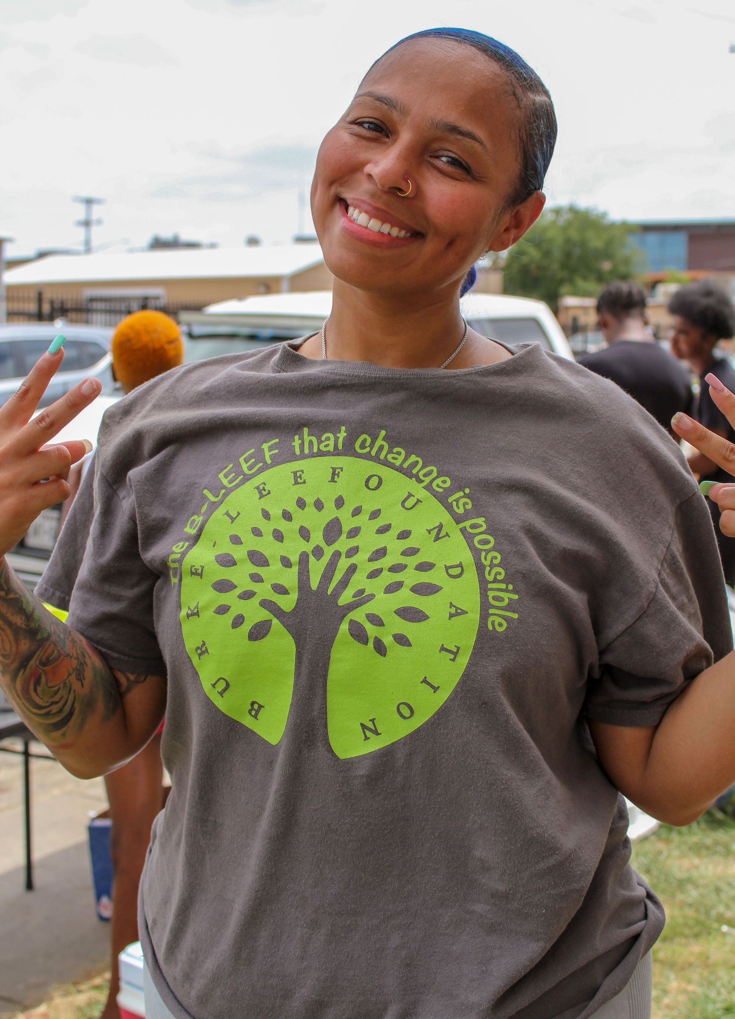 Gray t-shirt with green tree logo design shown from multiple angles.
