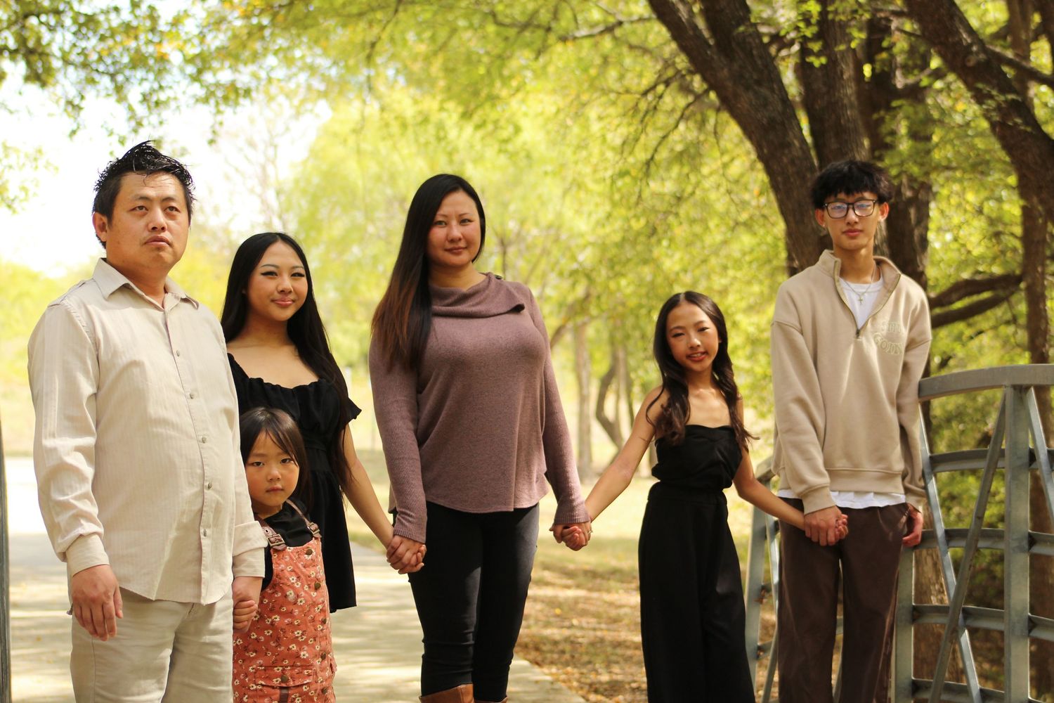Group walking together on a tree-lined path during golden hour.
