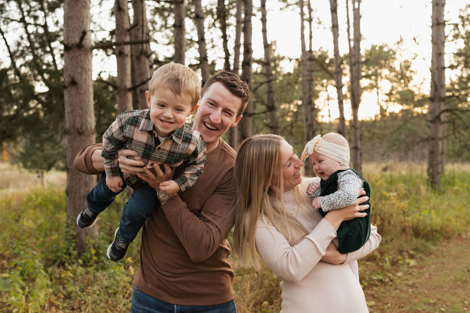 Family laughing together during an outdoor session in Rochester Minnesota