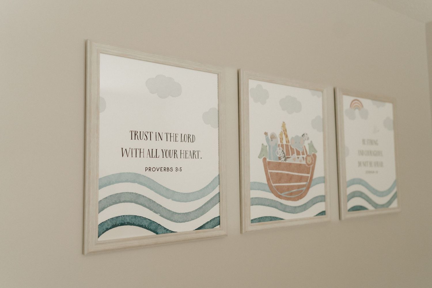 Three framed nursery wall prints featuring Noah's Ark, ocean waves, and a Proverbs 3:5 Bible verse in soft blue tones.