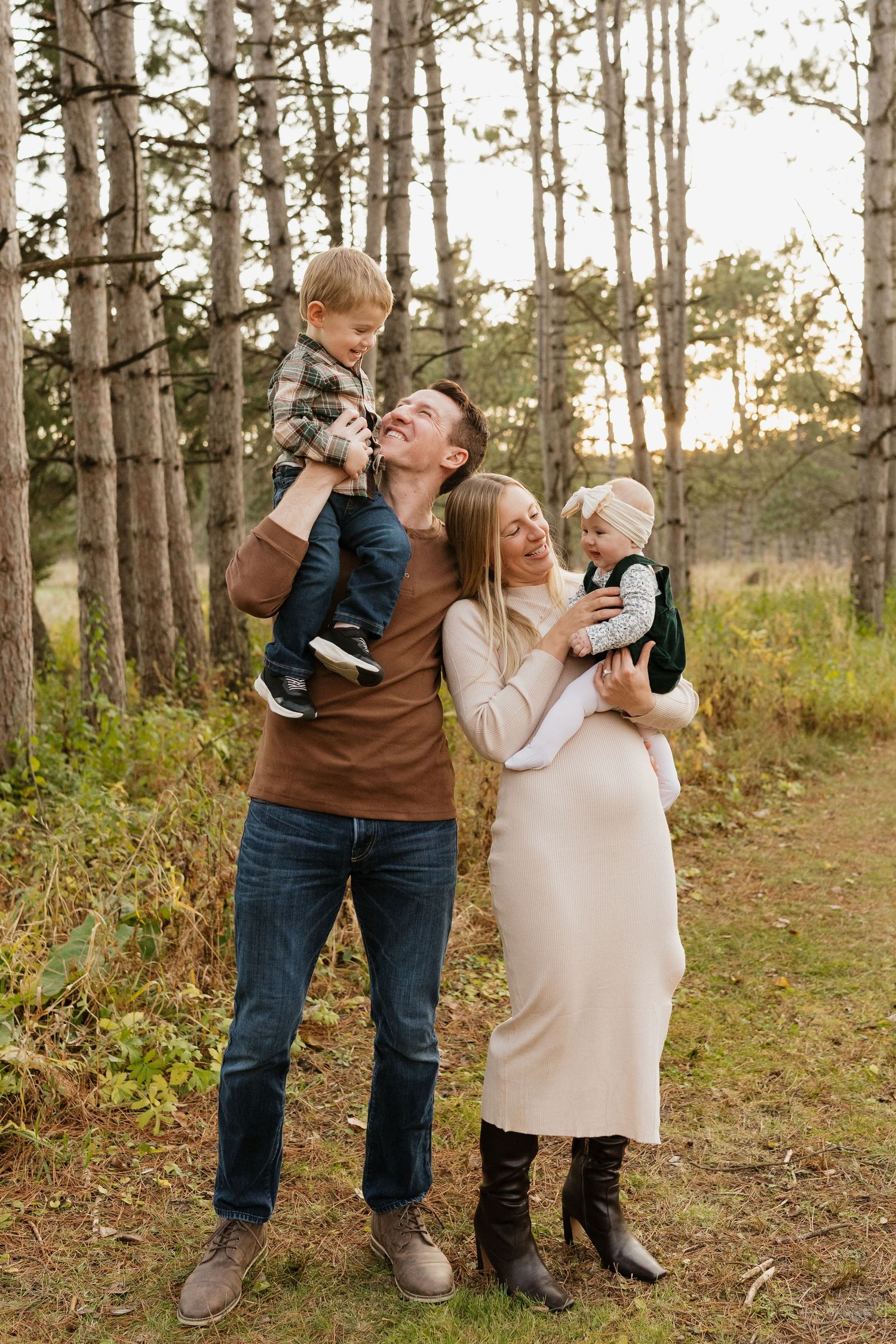 Parents and children cuddling during an outdoor family session in Rochester MN