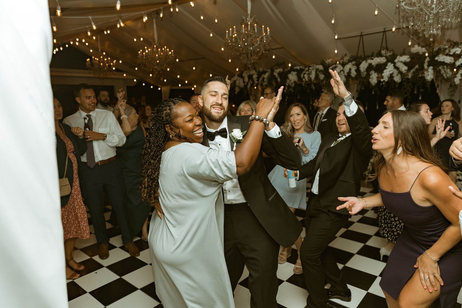 Wedding reception dance floor filled with guests enjoying the celebration.