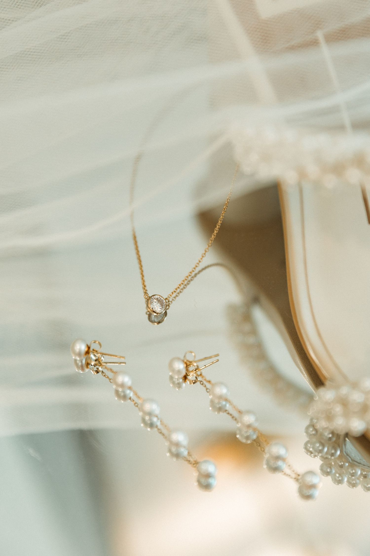 Delicate pearl and crystal wedding jewelry accessories on a light background.