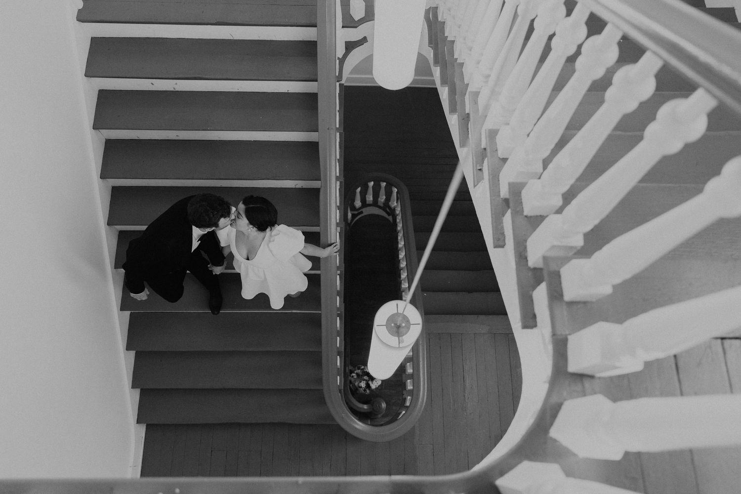 Black and white photo of a spiral staircase with dramatic shadows.